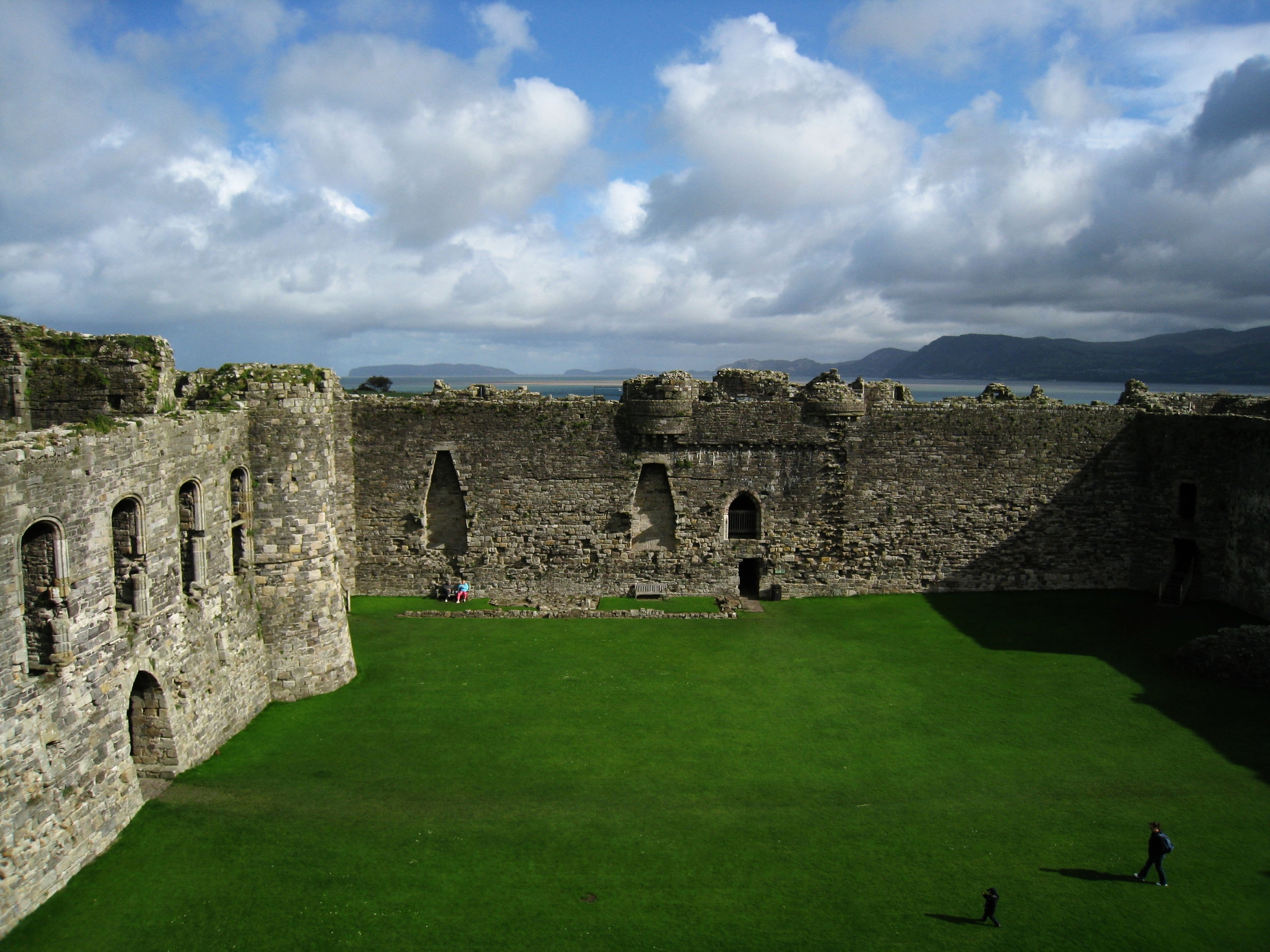  Wales--Beaumaris--Castle inner ward with the Orme promontory, Llandudno and Conway in the distance, separated by the sea 