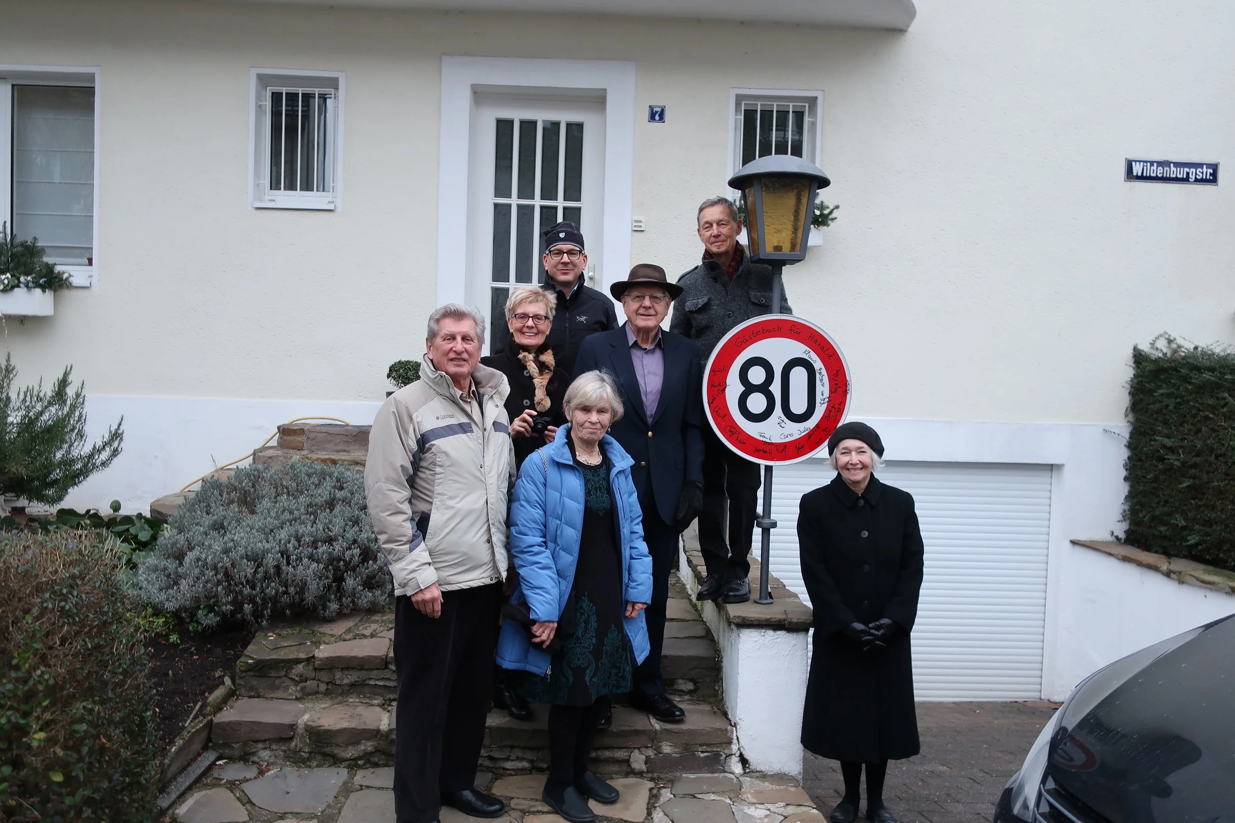  Cologne--Winter 2019--Grieser House on Wildenbergstrasse--Harald Grieser birthday--Karl Kindel, Christin Grieser-Kindel Judy, Eric and Paul Kindel, Harrald Grieser and Carrol Kindel in front of Harald's 80th Birthday sign 