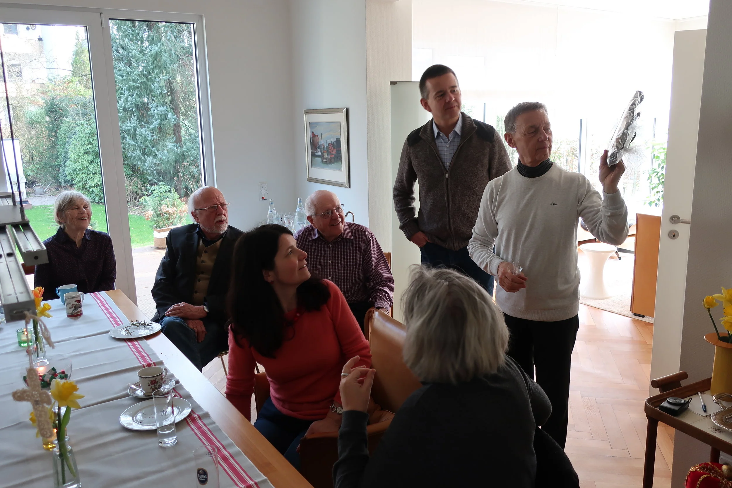  Cologne--Winter 2019--Harald Grieser's 80th birthday--Brunch at Grieser's--JUdy Kindel, Hannes Loesche, Paul Kindel, Klause and Barbara Kindel, and Heike Loesche and Harald Grieser, with a gift from Birgit Gruenert 