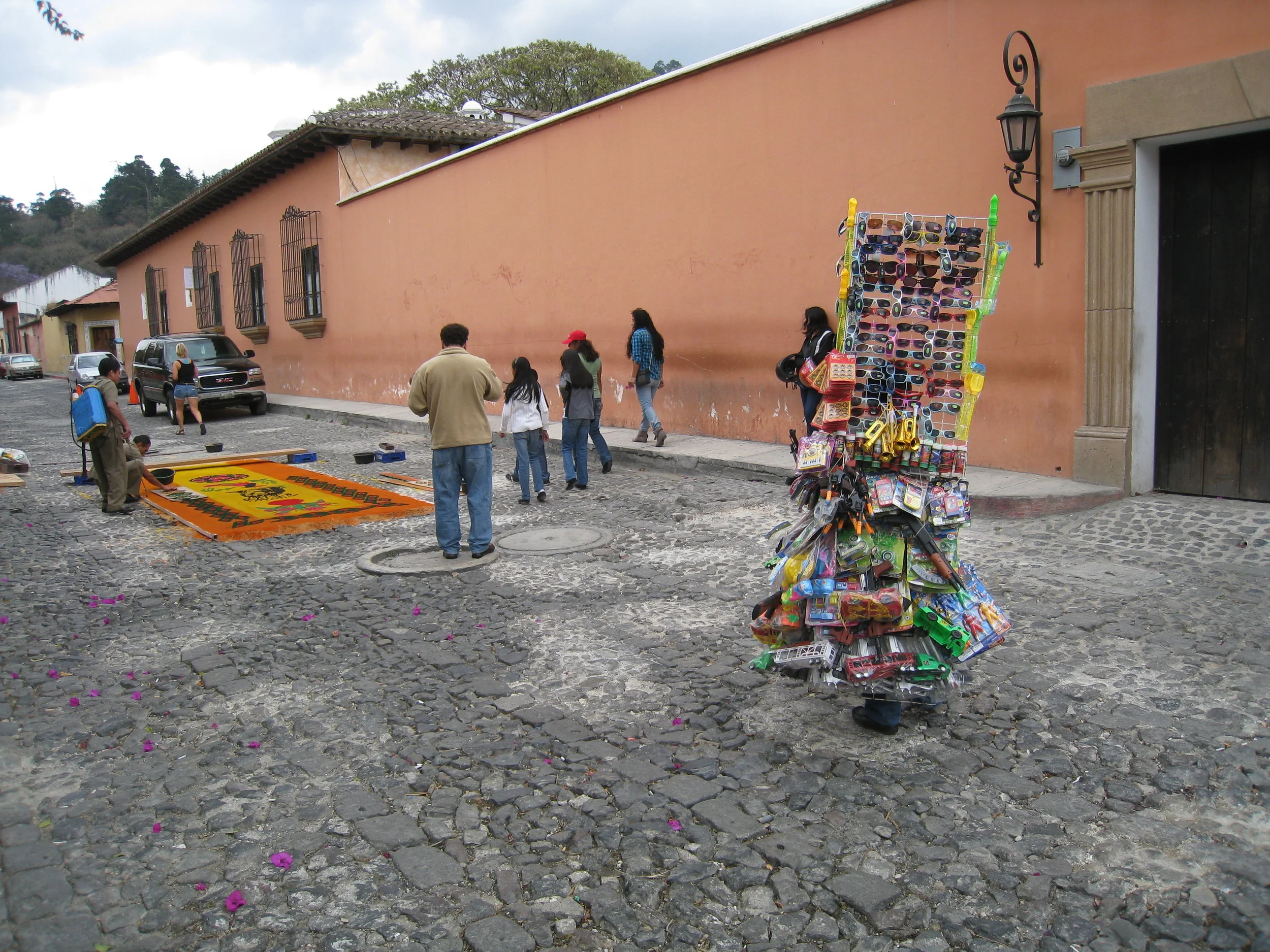  Antigua--Calle 3--Putting Alfombras (Rugs) in the street in honor of the procession. These are designed and made of colored sawdust, flowers and other plants, by the neighbors 