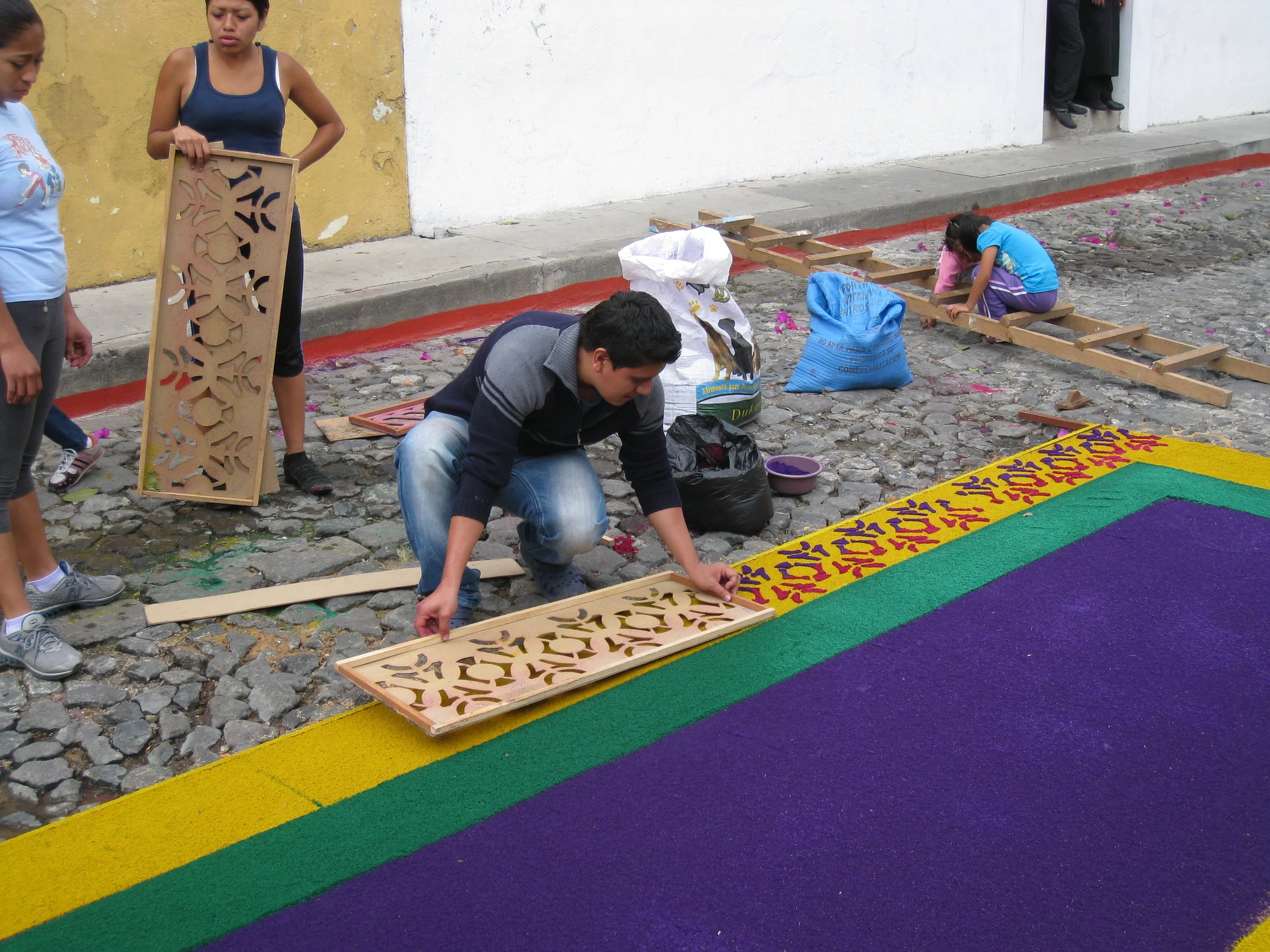  Antigua--Calle 3--Putting Alfombras (Rugs) in the street in honor of the procession. These are designed and made of colored sawdust, flowers and other plants, by the neighbors 