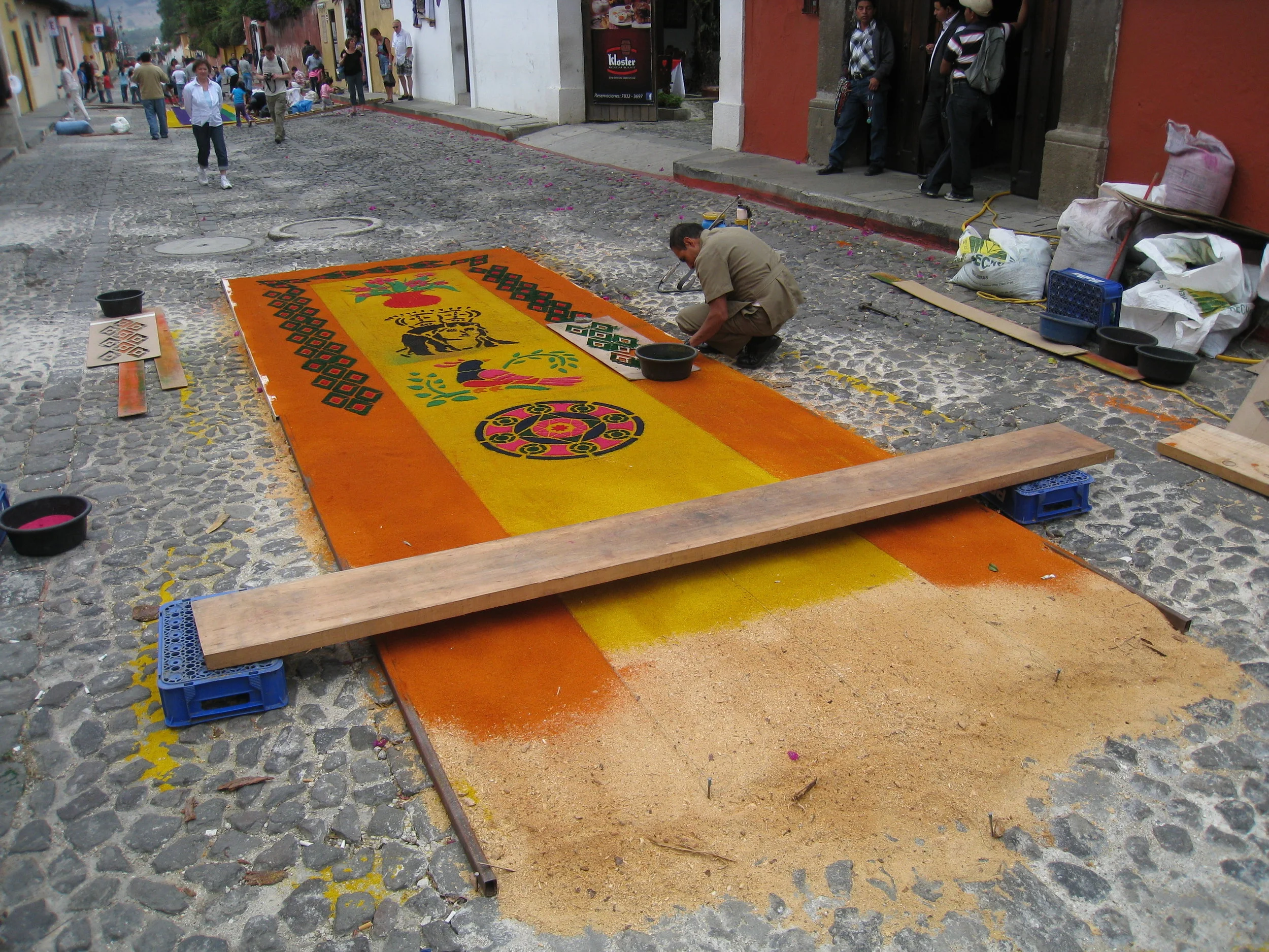  Antigua--Calle 3--Putting Alfombras (Rugs) in the street in honor of the procession. These are designed and made of colored sawdust, flowers and other plants, by the neighbors 