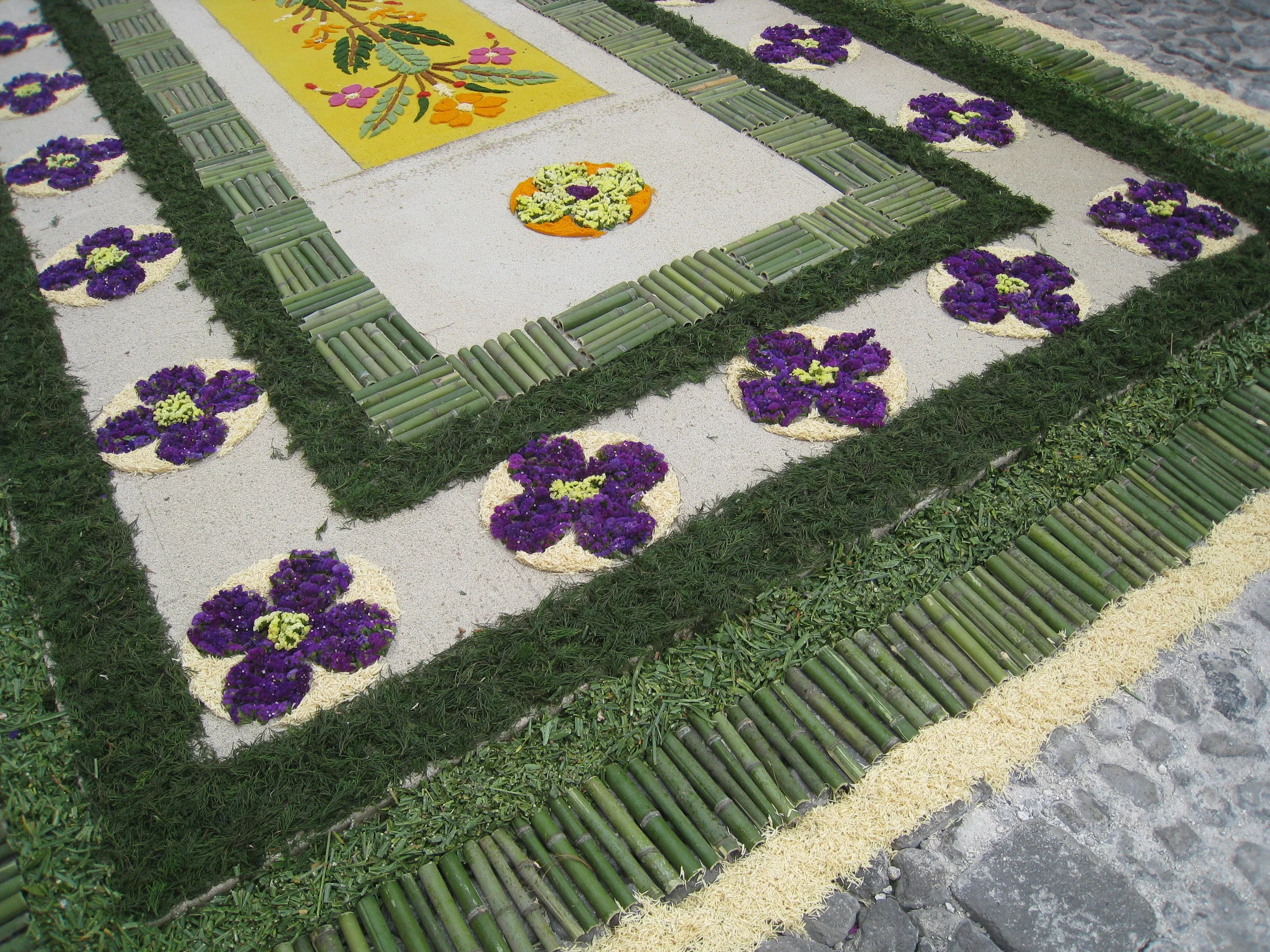  Antigua--Calle 3--Putting Alfombras (Rugs) in the street in honor of the procession. These are designed and made of colored sawdust, flowers and other plants, by the neighbors. 