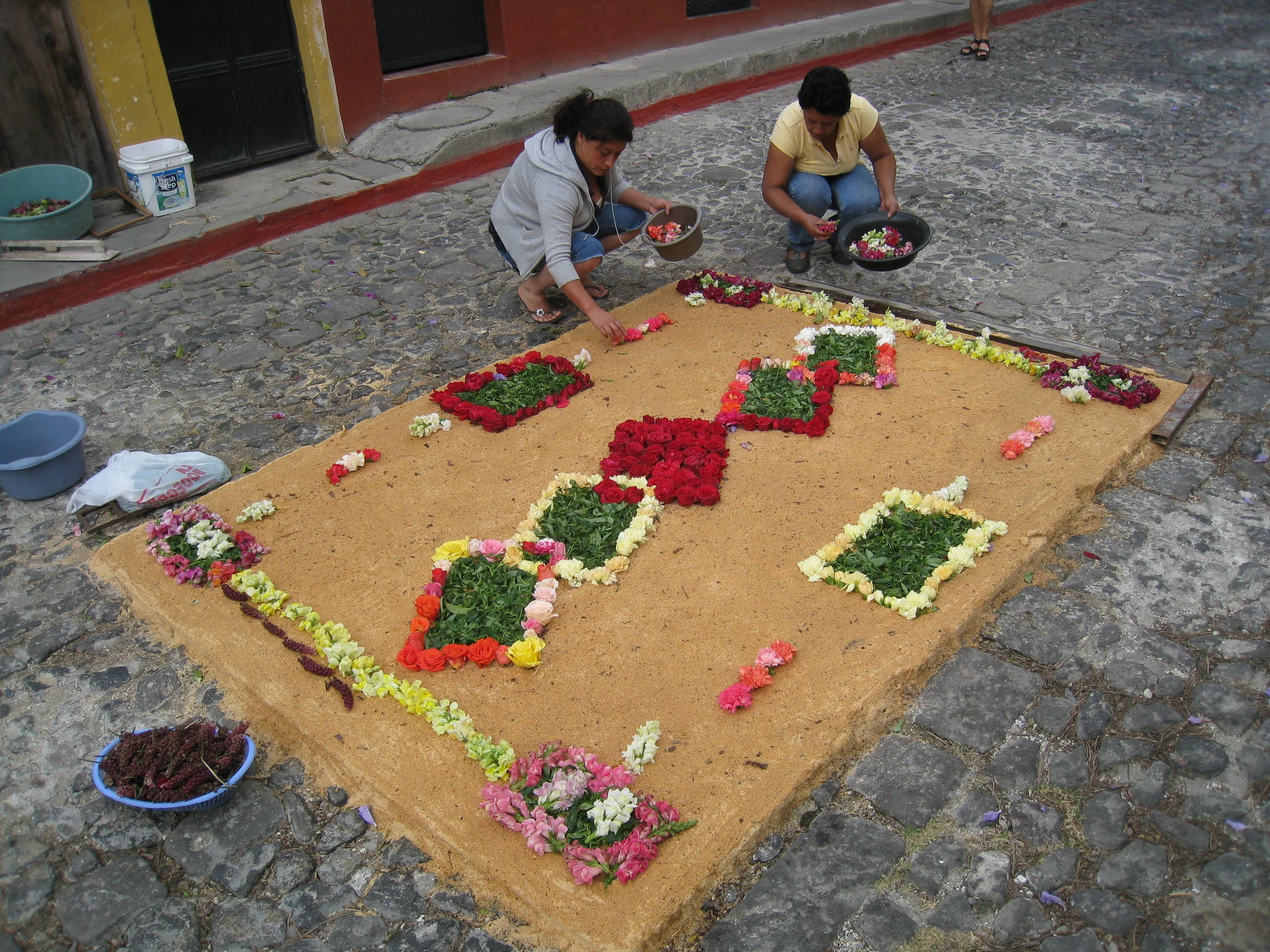  Antigua--Calle 3--Putting Alfombras (Rugs) in the street in honor of the procession. These are designed and made of colored sawdust, flowers and other plants, by the neighbors. 