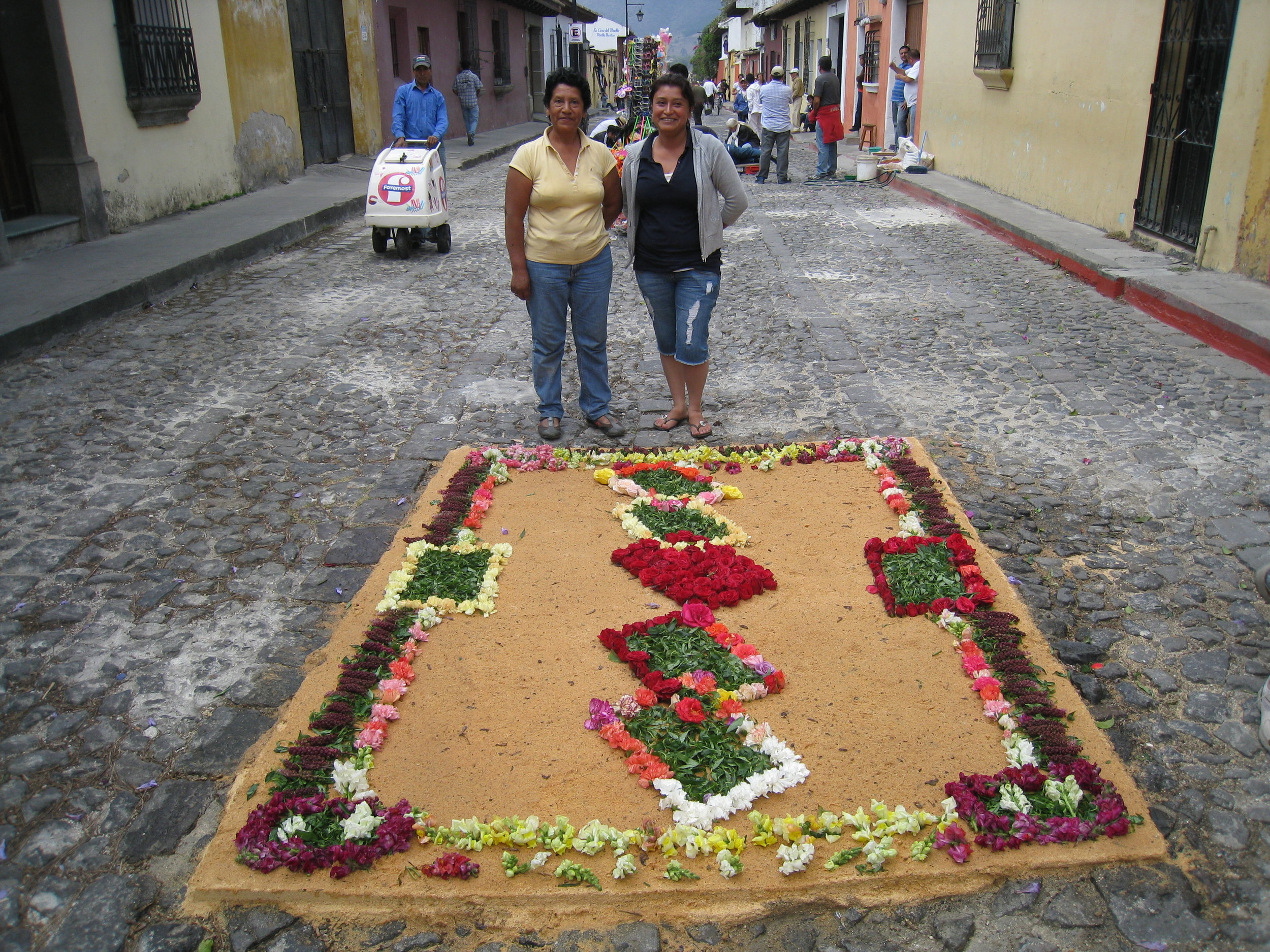  Antigua--Calle 3--Putting Alfombras (Rugs) in the street in honor of the procession. These are designed and made of colored sawdust, flowers and other plants, by the neighbors. The proud designers and makers 