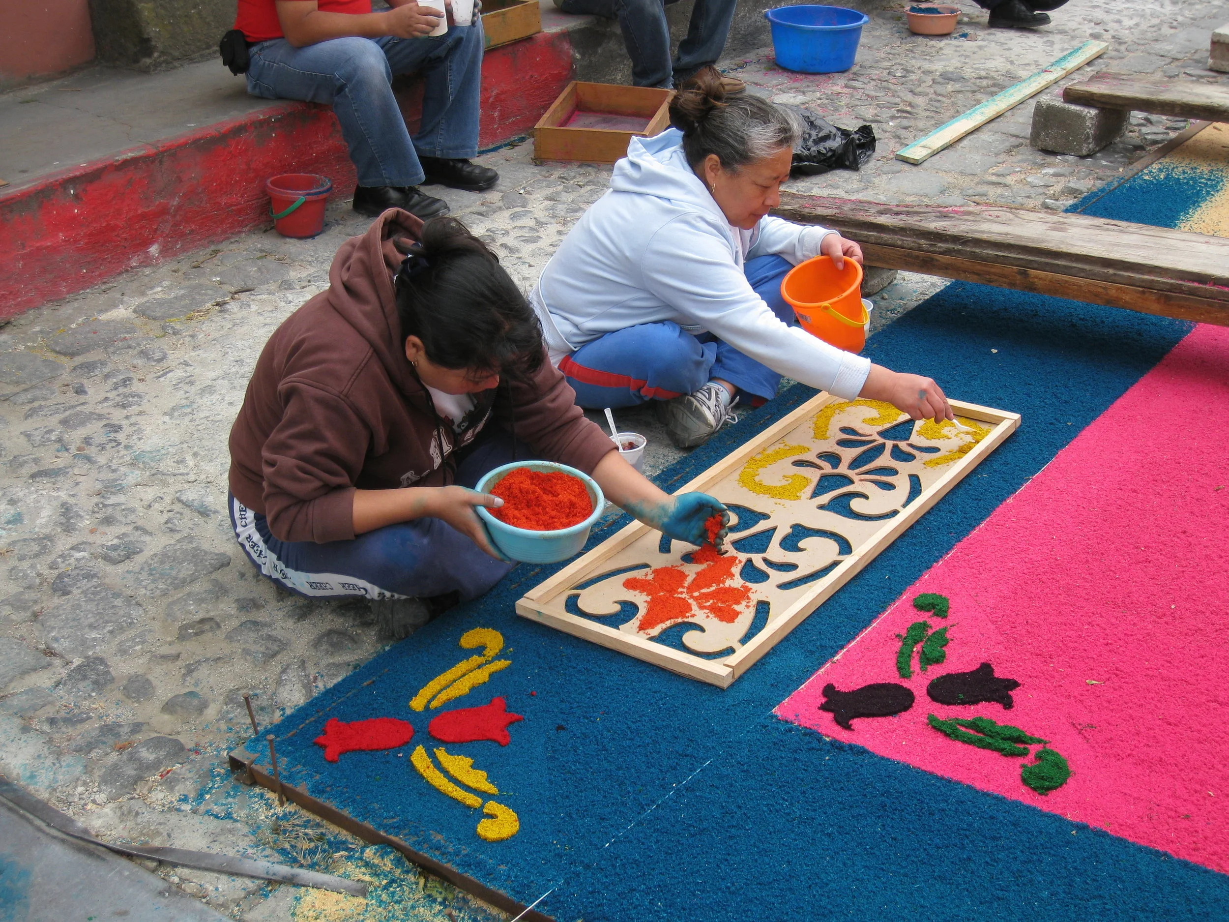  Antigua--Calle 3--Putting Alfombras (Rugs) in the street in honor of the procession. These are designed and made of colored sawdust, flowers and other plants, by the neighbors. 
