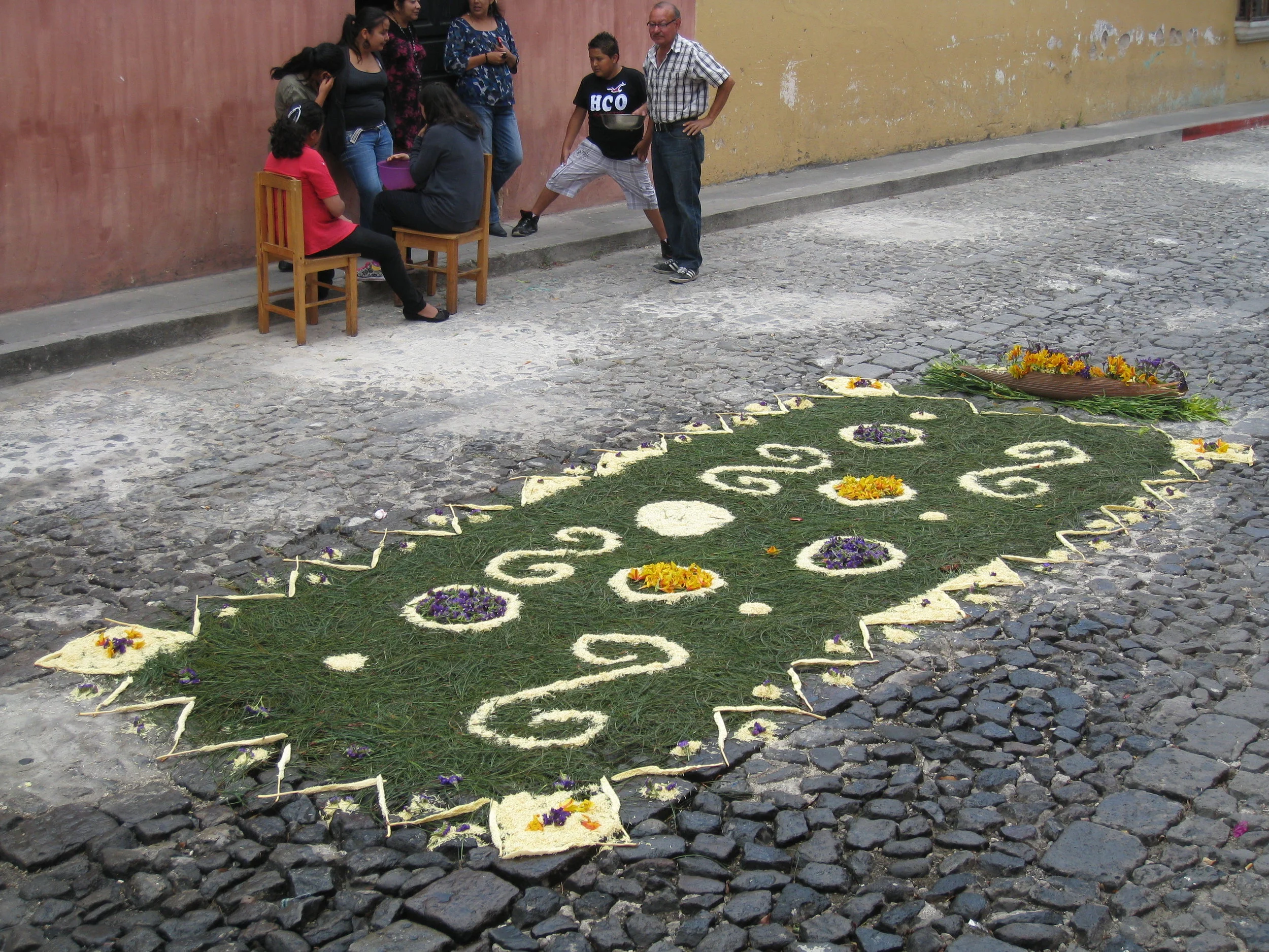  Antigua--Calle 3--Putting Alfombras (Rugs) in the street in honor of the procession. These are designed and made of colored sawdust, flowers and other plants, by the neighbors. This one is based on pine needles, a Mayan tradition 