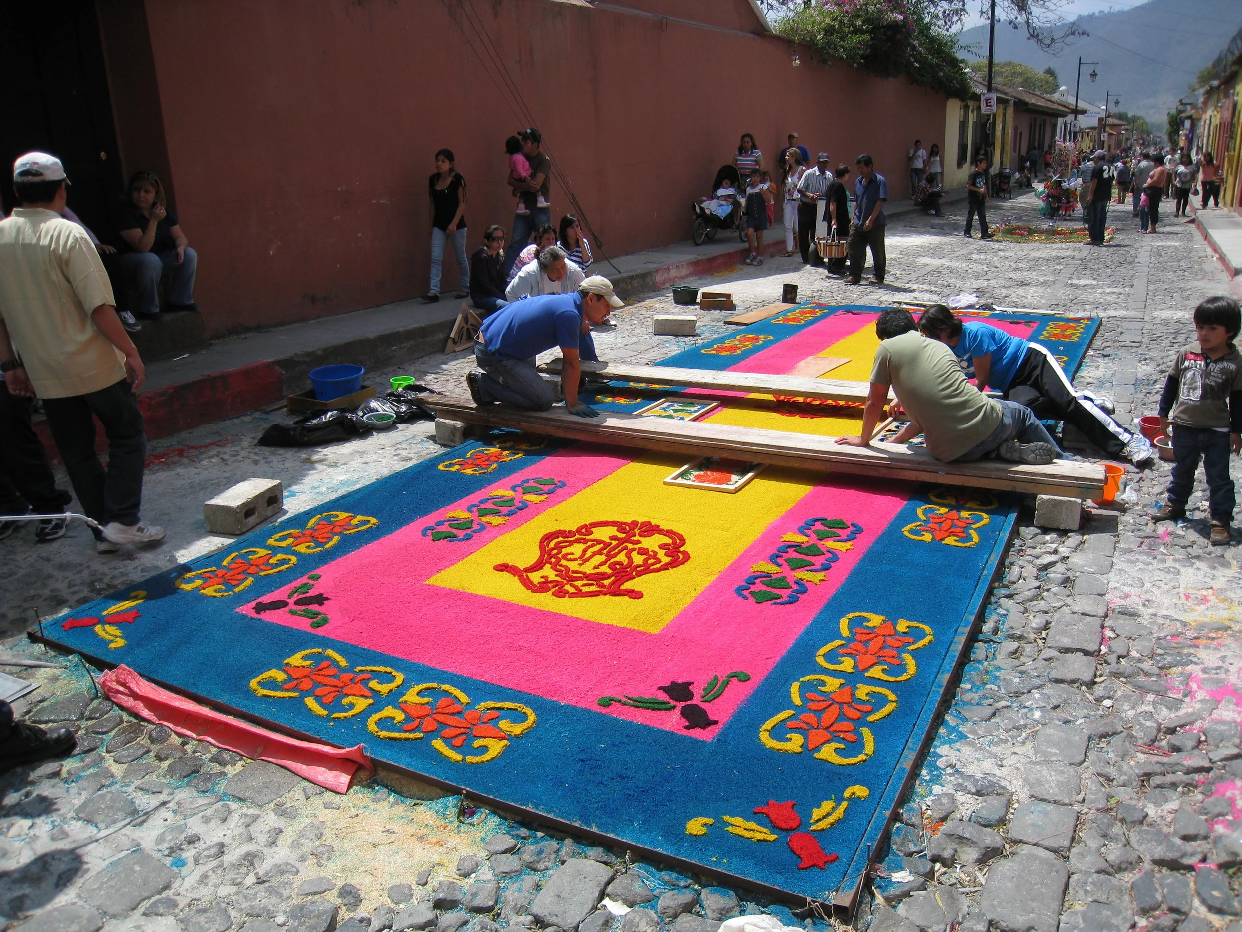  Antigua--Calle 3--Putting Alfombras (Rugs) in the street in honor of the procession. These are designed and made of colored sawdust, flowers and other plants, by the neighbors. This was one of the more elaborate 