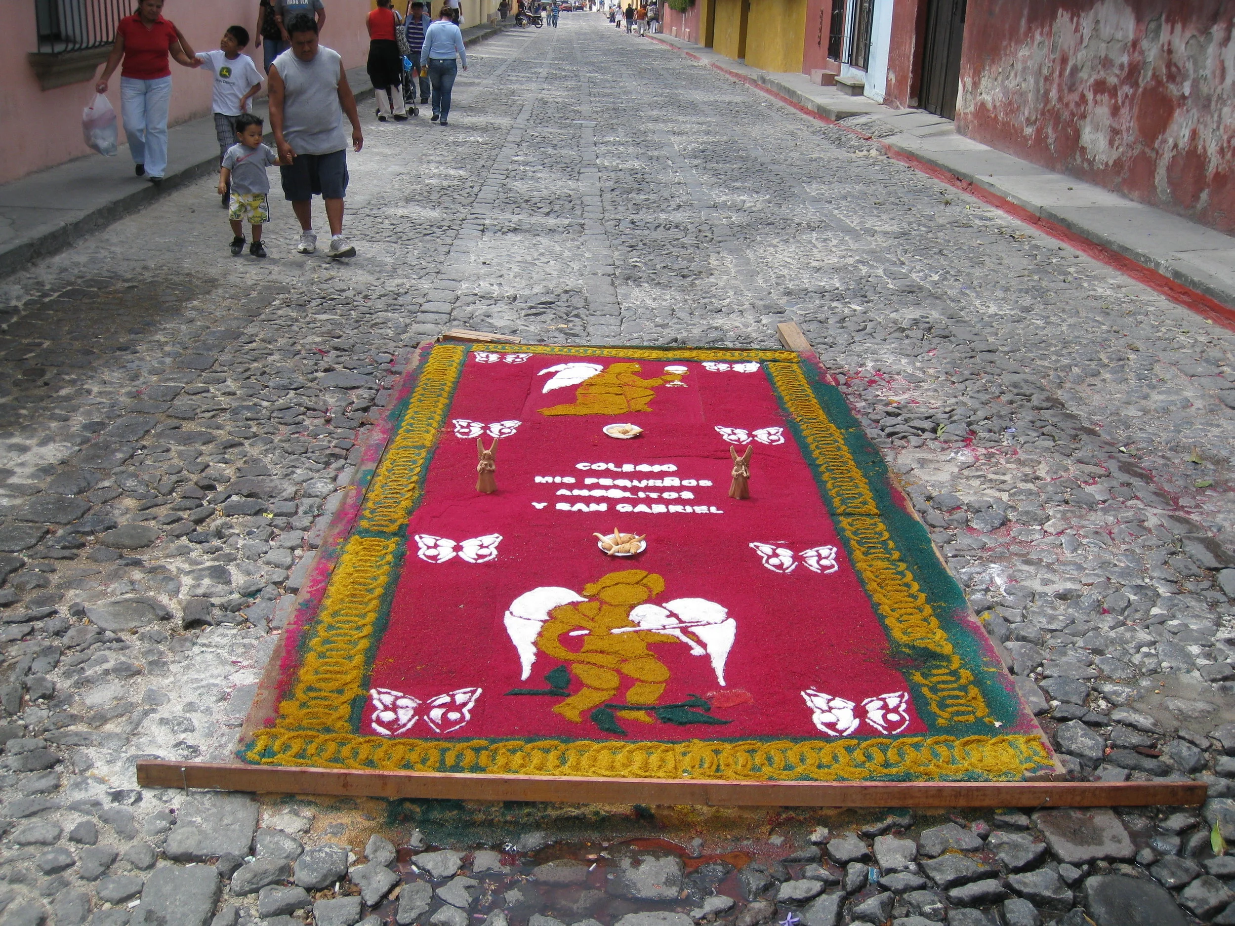  Antigua--Calle 3--Putting Alfombras (Rugs) in the street in honor of the procession. These are designed and made of colored sawdust, flowers and other plants, by the neighbors. This one was done by school children 