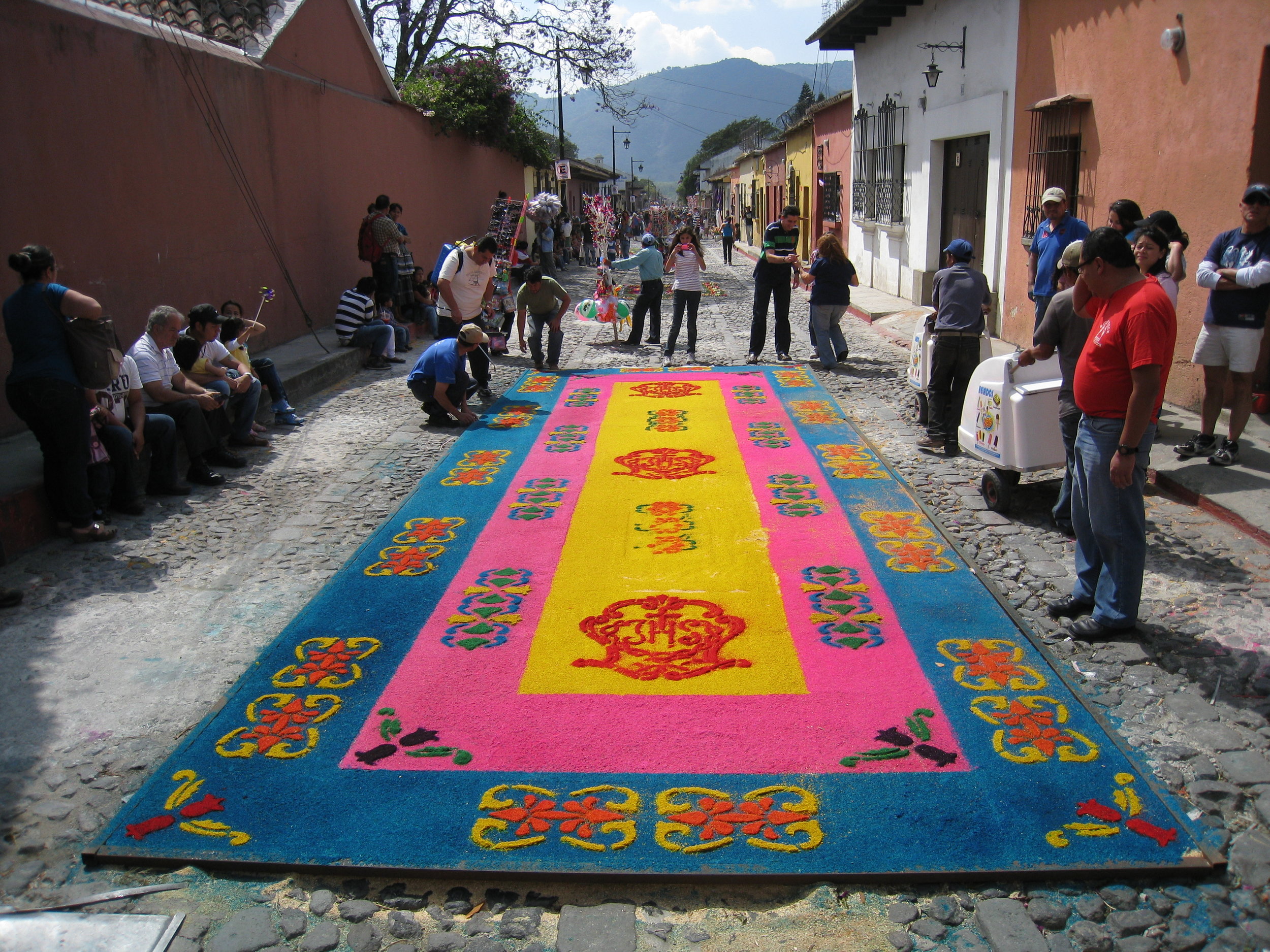  Antigua--Calle 3--Putting Alfombras (Rugs) in the street in honor of the procession. These are designed and made of colored sawdust, flowers and other plants, by the neighbors. This was complete a half hour before the procession came 