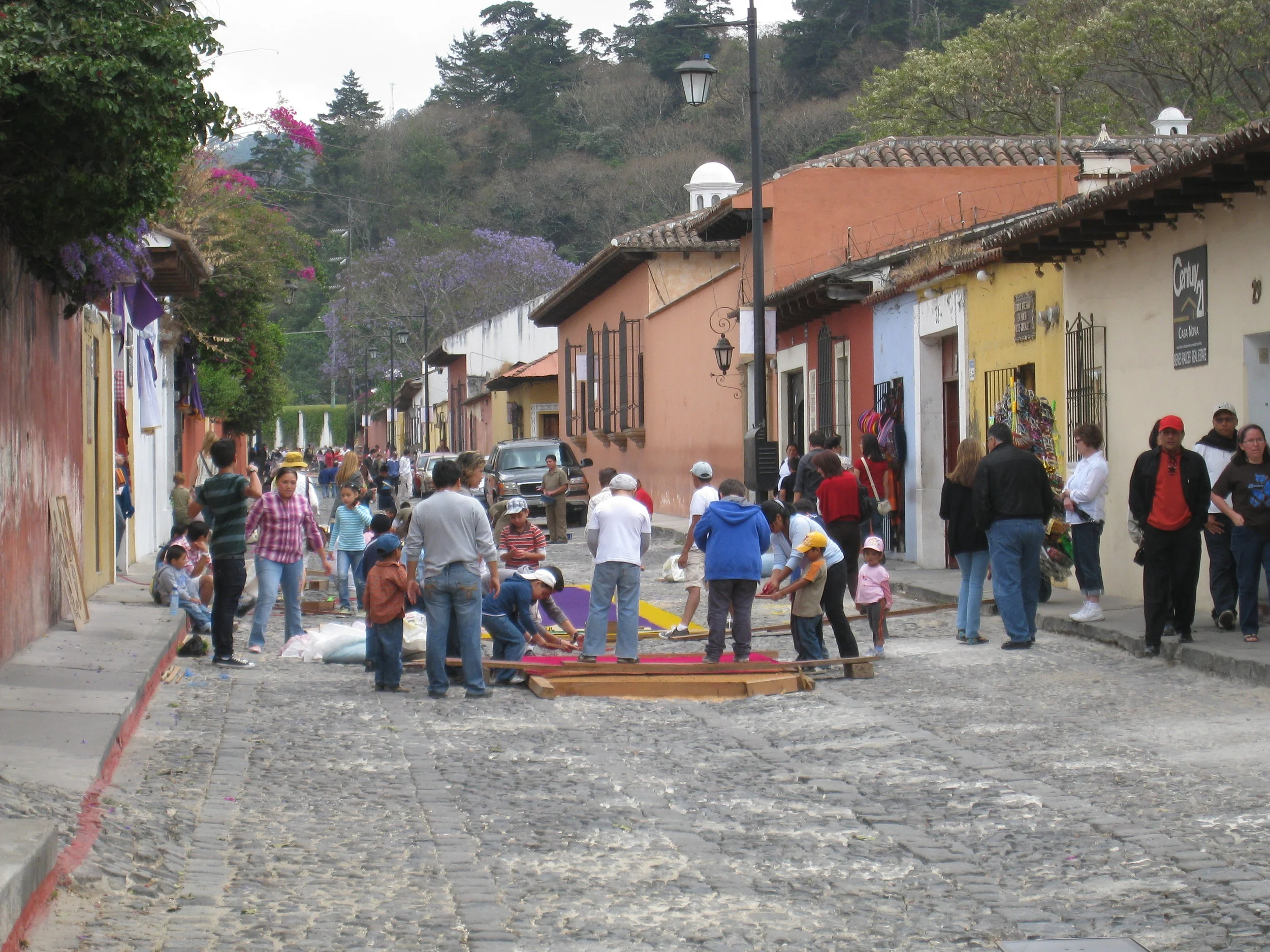  Antigua 2012--Calle 3--Putting Alfombras (Rugs) in the street in honor of the procession. These are designed and made of colored sawdust, flowers and other plants, by the neighbors 