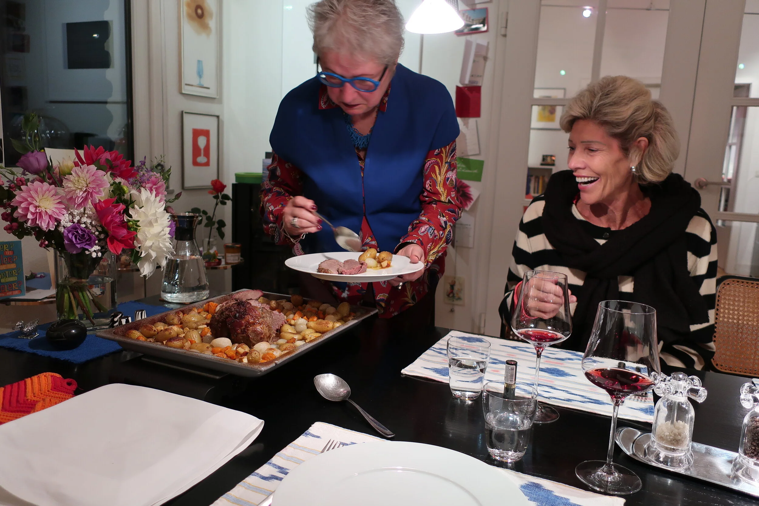  Cologne 2019--Dinner of smoked salmon and lamb at Renate and Joerg's-- Renate Schneider serving with Debbie Schreiber 