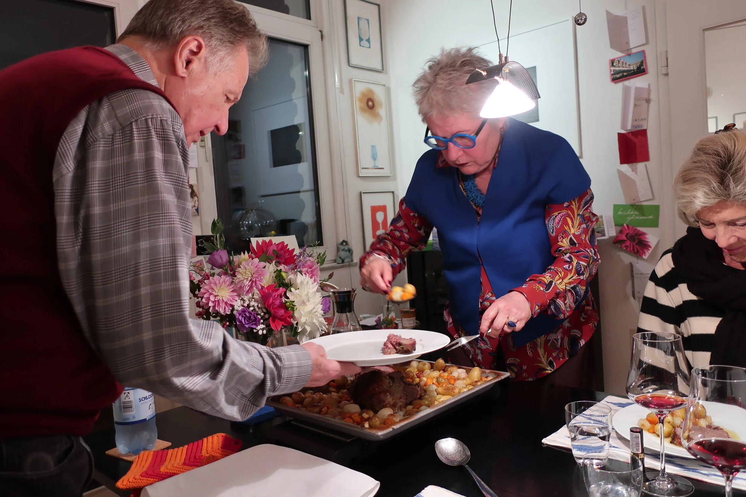  Cologne 2019--Dinner of smoked salmon and lamb at Renate and Joerg's-- Joerg Goralewski and Renate Schneider serving with Debbie Schreiber 