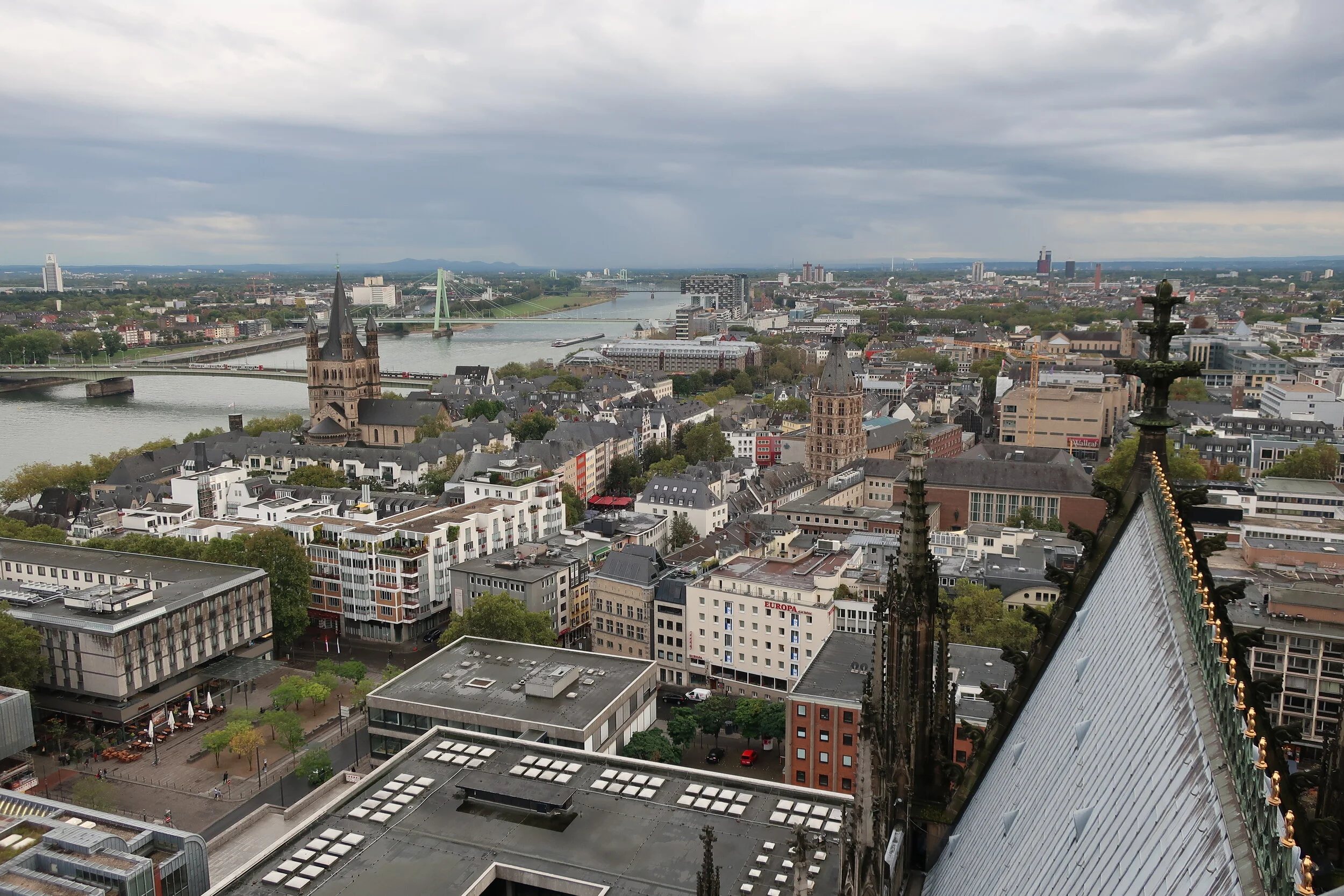  Cologne 2019--Cologne Cathedral insider's tour of the high reaches of the Cathedral--View from the modern steeple--the Rhine with the Cathedral roof in front, looking south (downriver) 