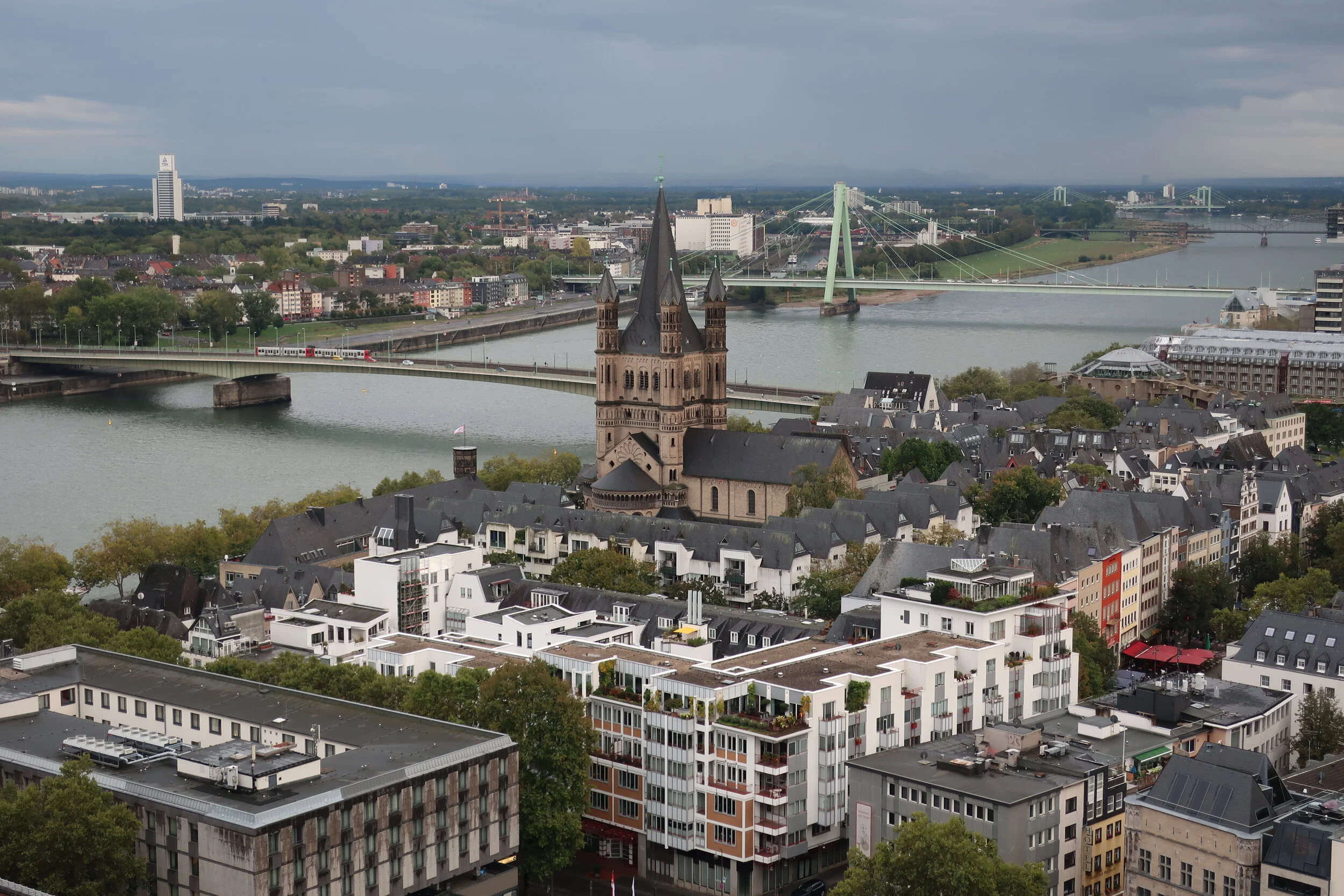  Cologne 2019--Cologne Cathedral insider's tour of the high reaches of the Cathedral--View from the modern steeple--the Rhine with the Cathedral roof in front, looking south (downriver) past the Severin Bridge 