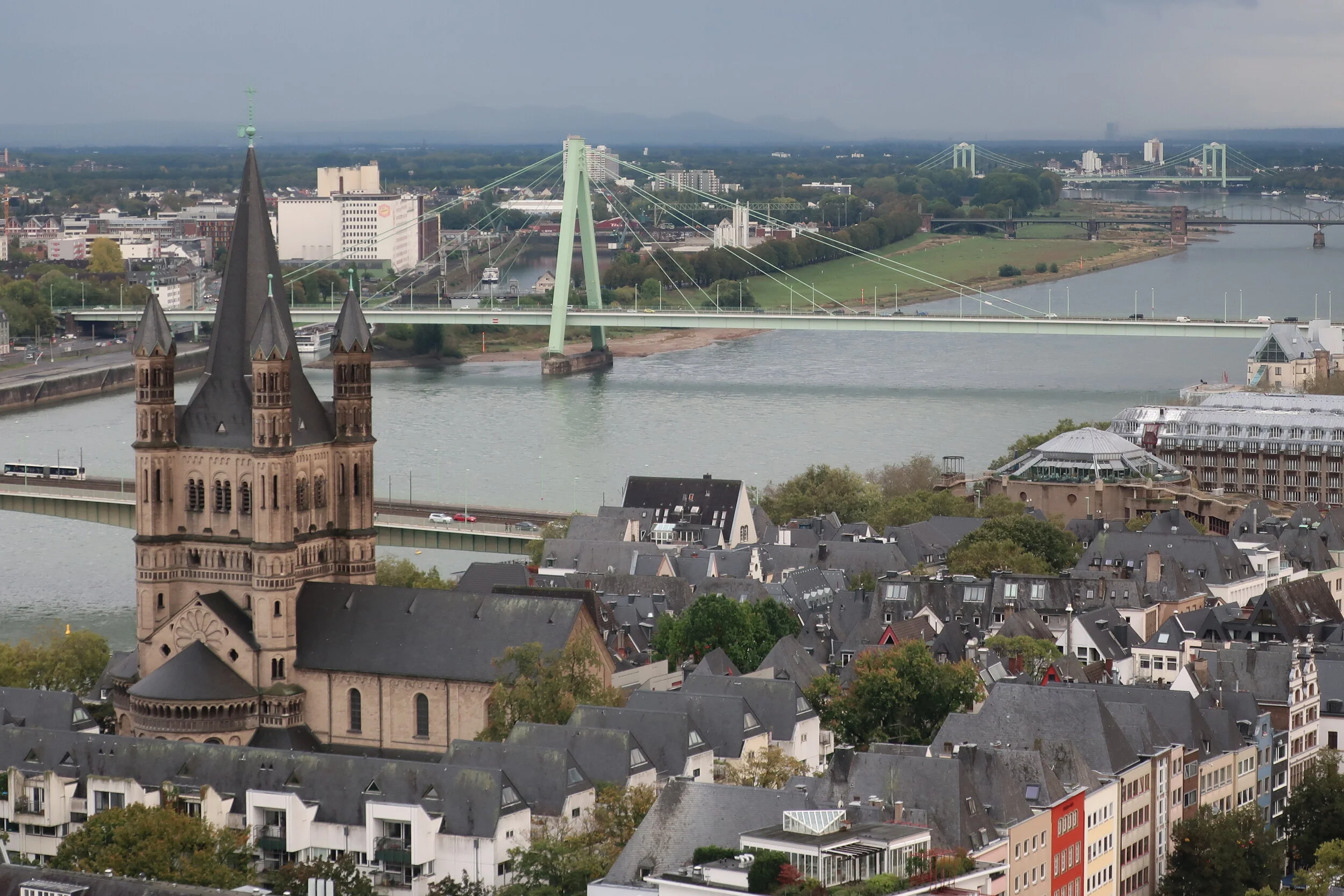  Cologne 2019--Cologne Cathedral insider's tour of the high reaches of the Cathedral--View from the modern steeple--the Rhine with the Cathedral roof in front, looking south (downriver) past the Severin Bridge 