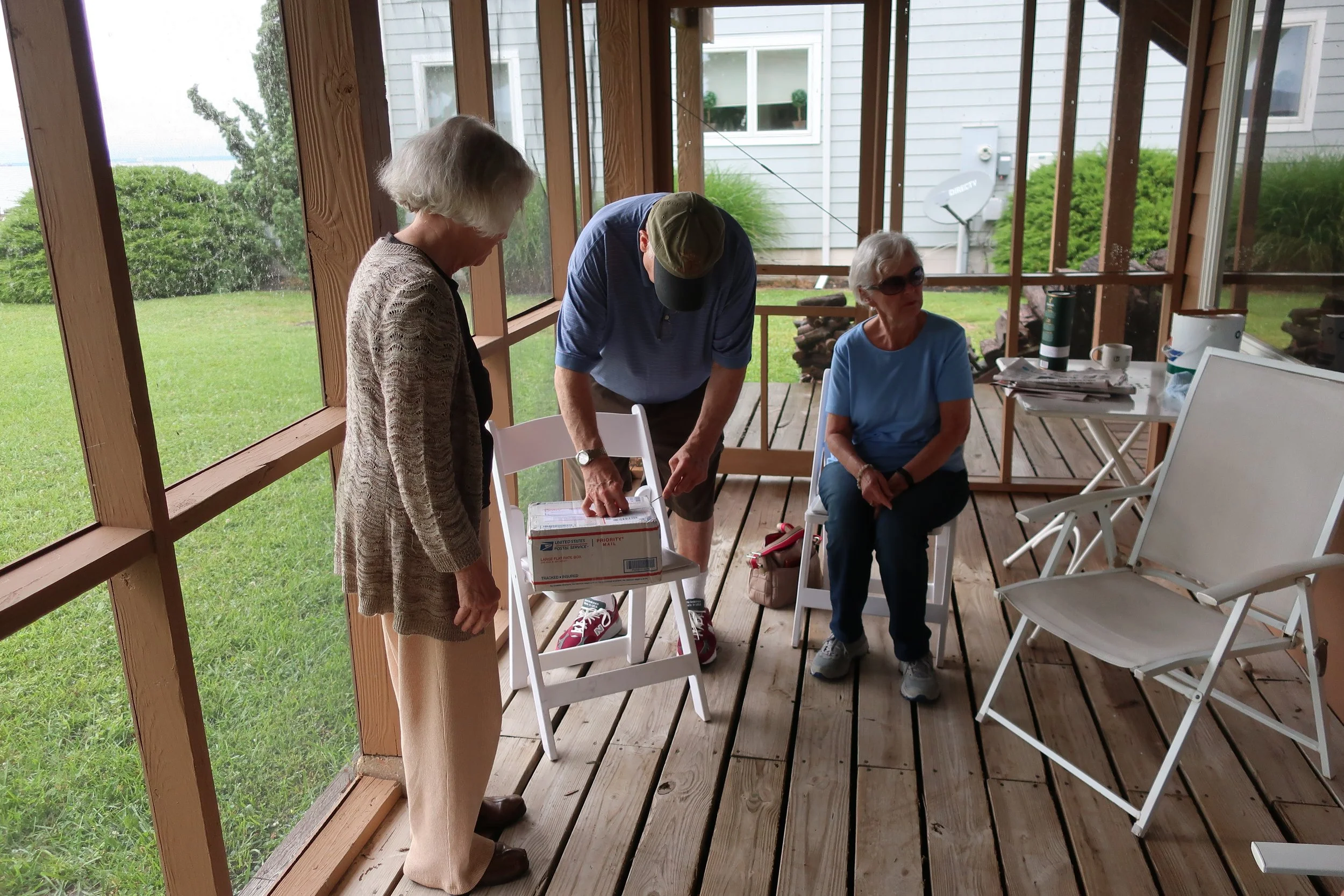  Kent Island--June 2022--50th Wedding Celebration--Carrol Benner Kindel, Jamie Ennis and Marilyn Fanning opening package from Roger King 