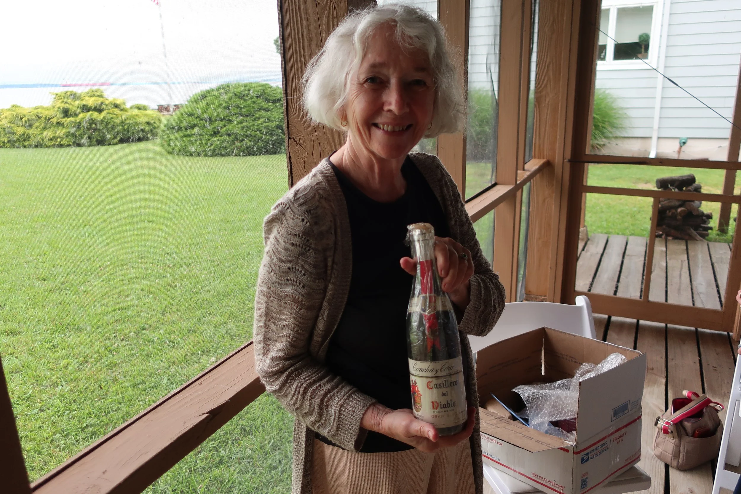  Kent Island--June 2022--50th Wedding Celebration--Carrol Benner Kindel, opening 1972 Chilean bottle of Casa del Diablo wine from Roger King.  