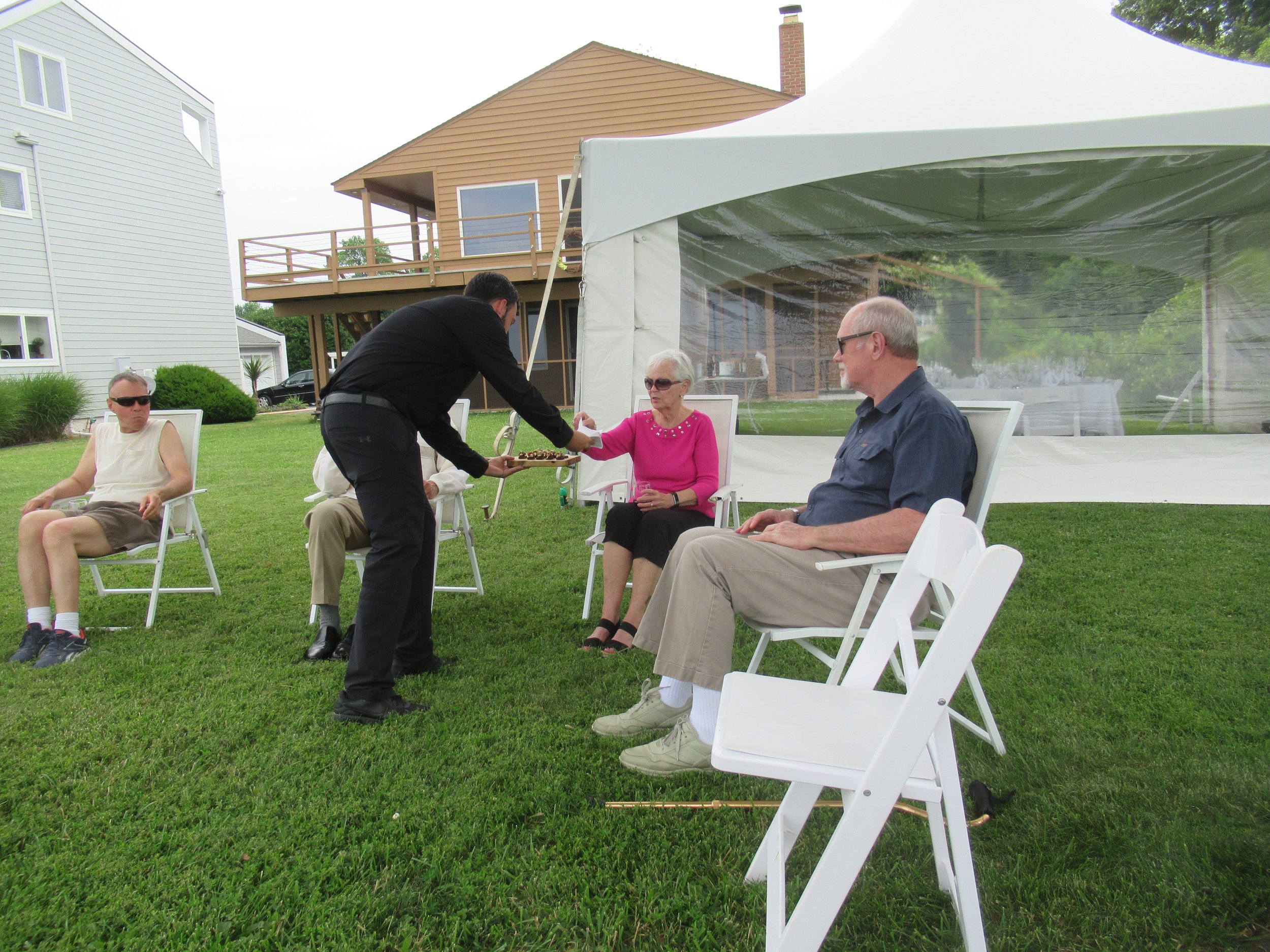  Kent Island--June 2022--50th Wedding Celebration--Steve Kohlhass, Mike serving starters to Marilyn Fanning and Rick Schreiber 