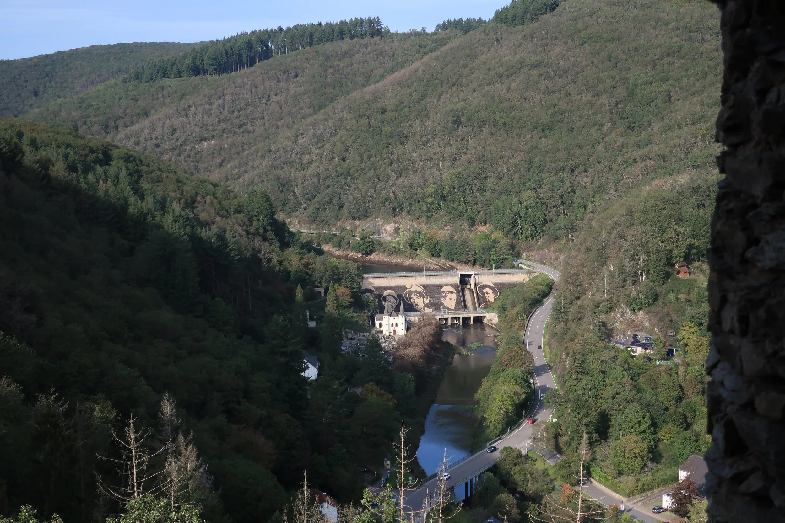  Germany 2023--Kindel 50th Anniversary Trip--Luxembourg, Vianden--Castle--Dam with new faces painted on it of former workers 