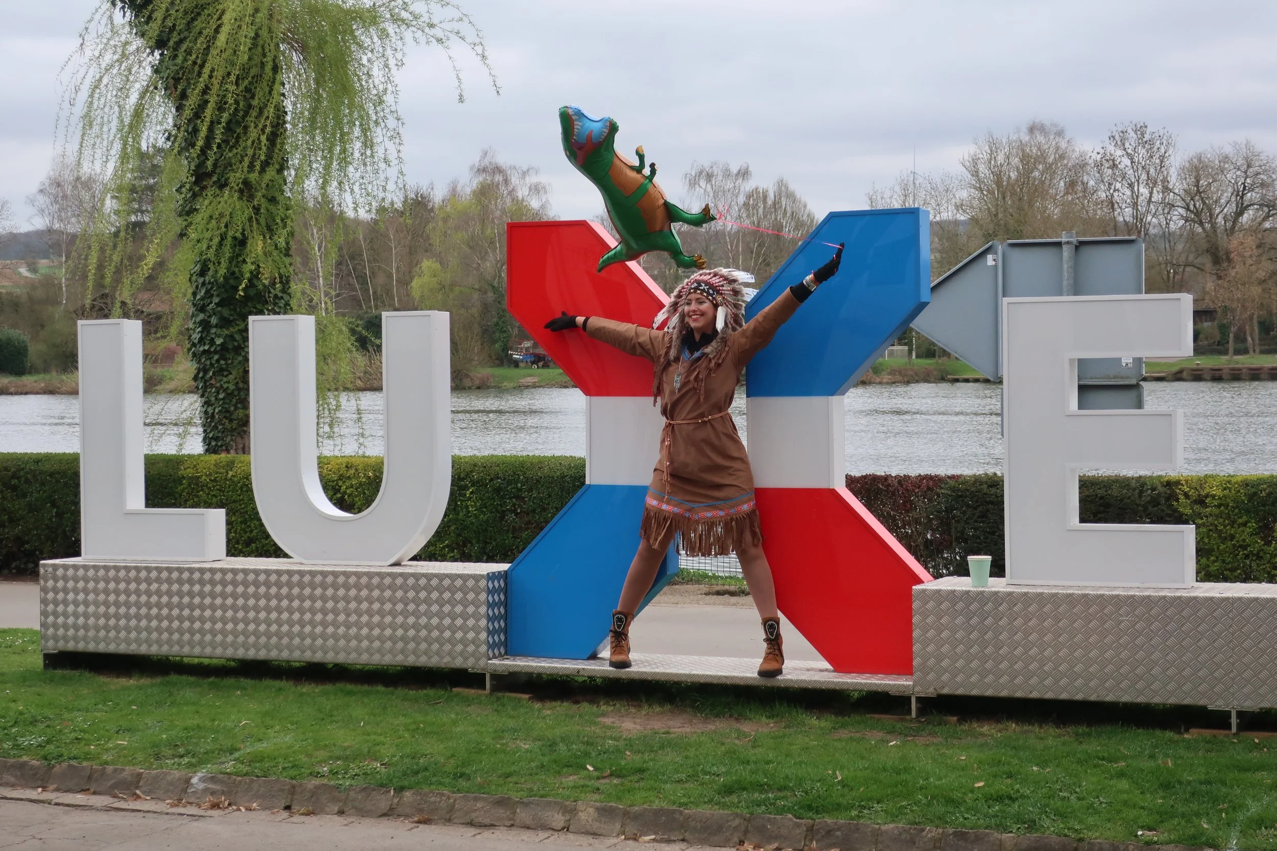  Luxembourg 2025--Remich Cavalcade Celebration--An exhuberant celebrant on the iconic "Luxembourg" sign. 