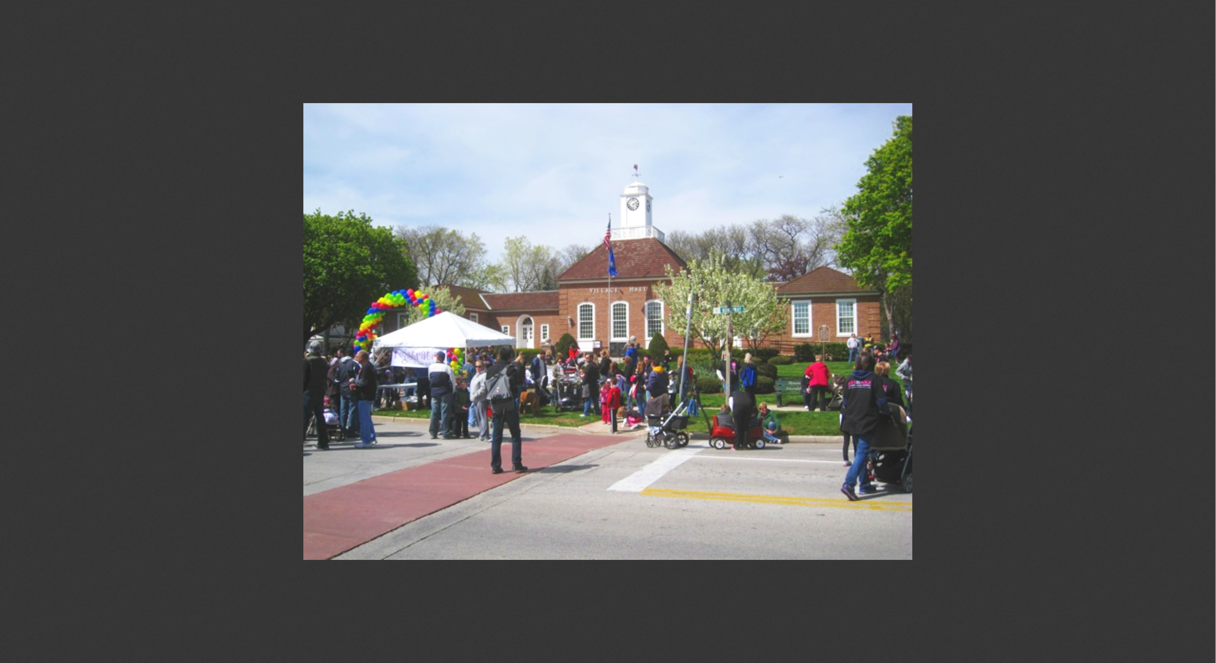   Slide (Administration Bldg.):  Here is a photo of the Village Hall during some kind of village celebration. The village was governed by a Village Board and School Board, with a hired city manager. 