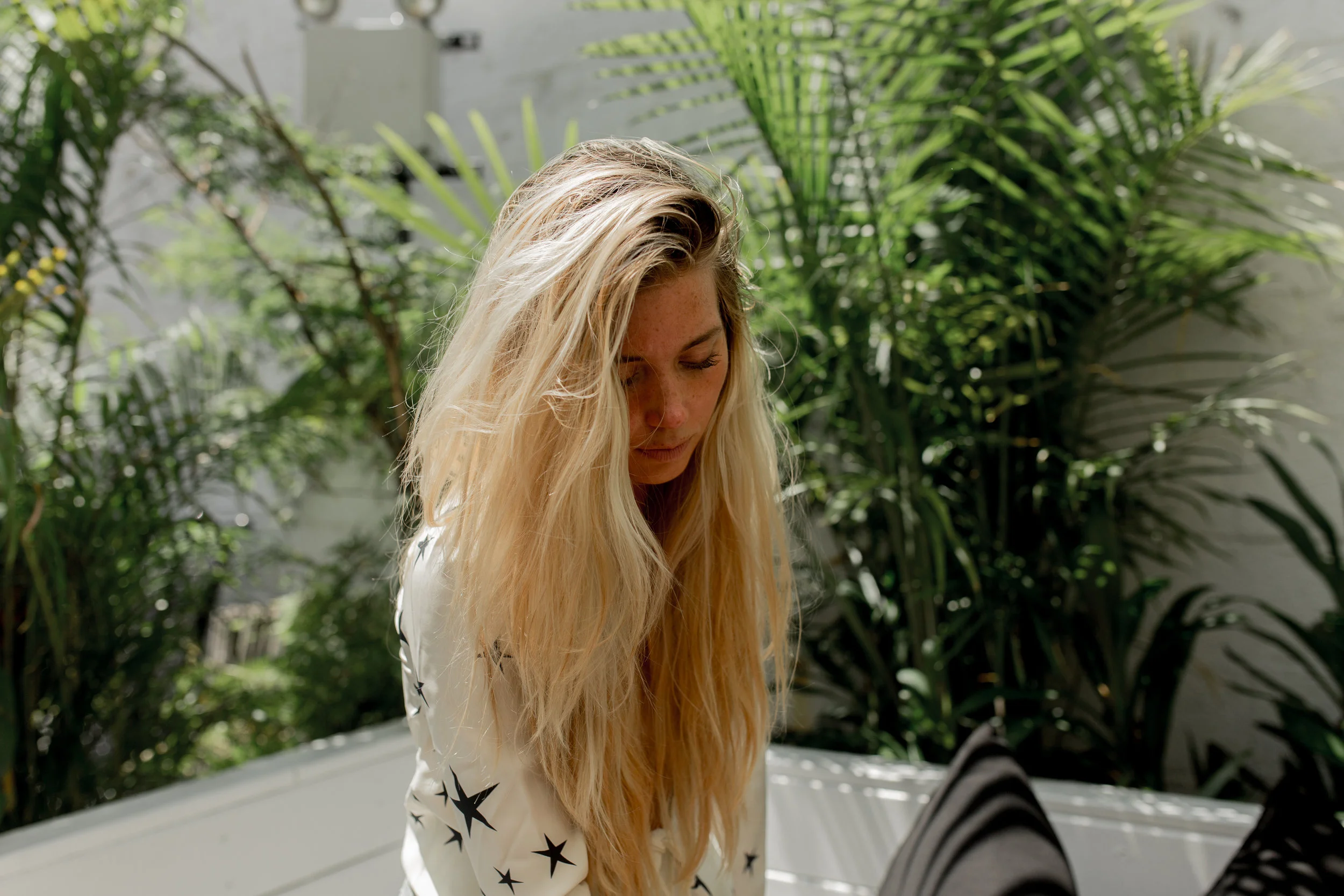 Denvre is wearing: Réalisation Par's "The Bianca - Cream Superstar" top.