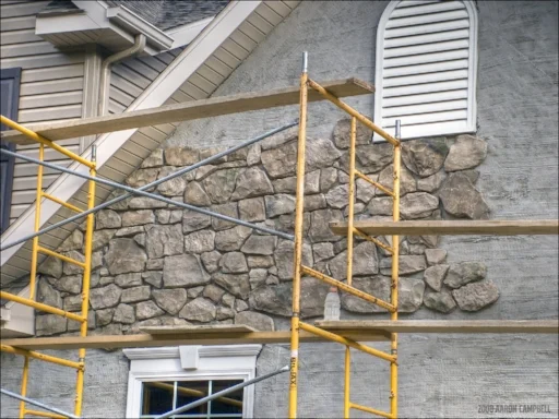 After thirty feet, a wood structure won't support stone as a practical option.