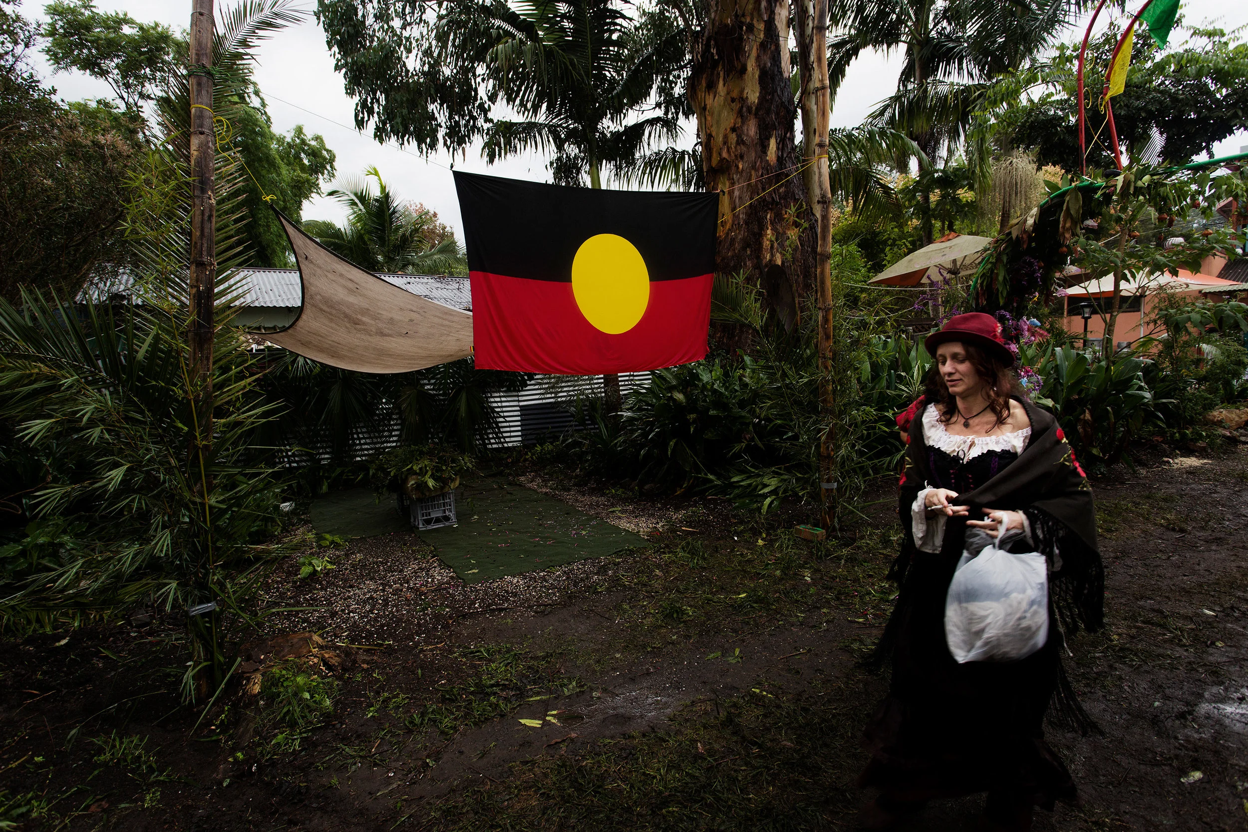  An Aboriginal flag hangs along the footpath behind the Oasis Cafe in Nimbin NSW, Australia. The local aboriginal Whiyabul clan believe the area is protected by the Nimbinjee spirits, which is where the word Nimbin originates from. 