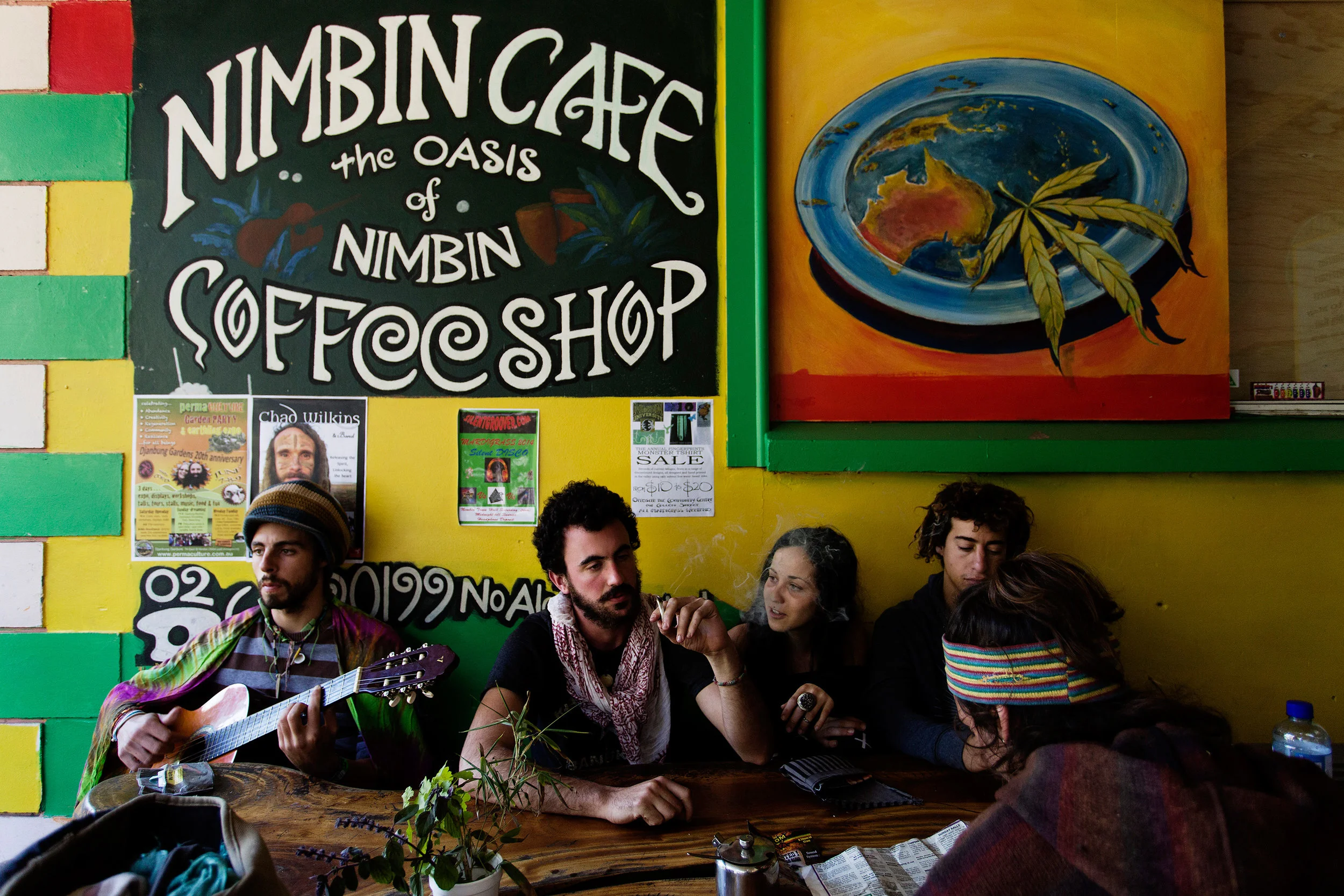  Backpackers kick back while sharing a joint in the Oasis Cafe, Nimbin NSW, Australia. Several shops in town turn a blind-eye to customers using marijuana. 