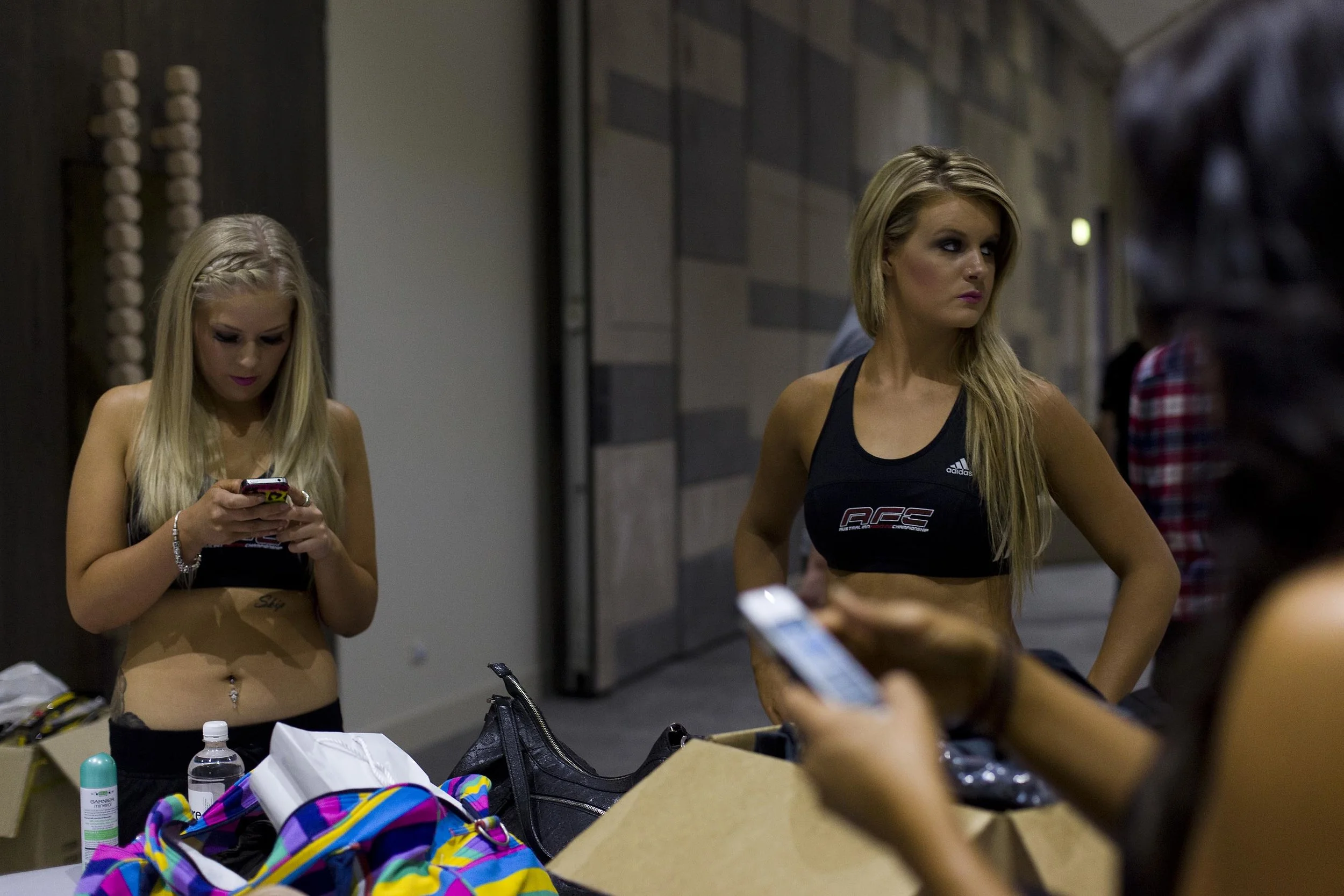  Ring girls Ashlee Savaris (L) and Carly Loftus prepare themselves backstage before the fight at the Australian Fighting Championship, Melbourne Pavilion, Victoria. 