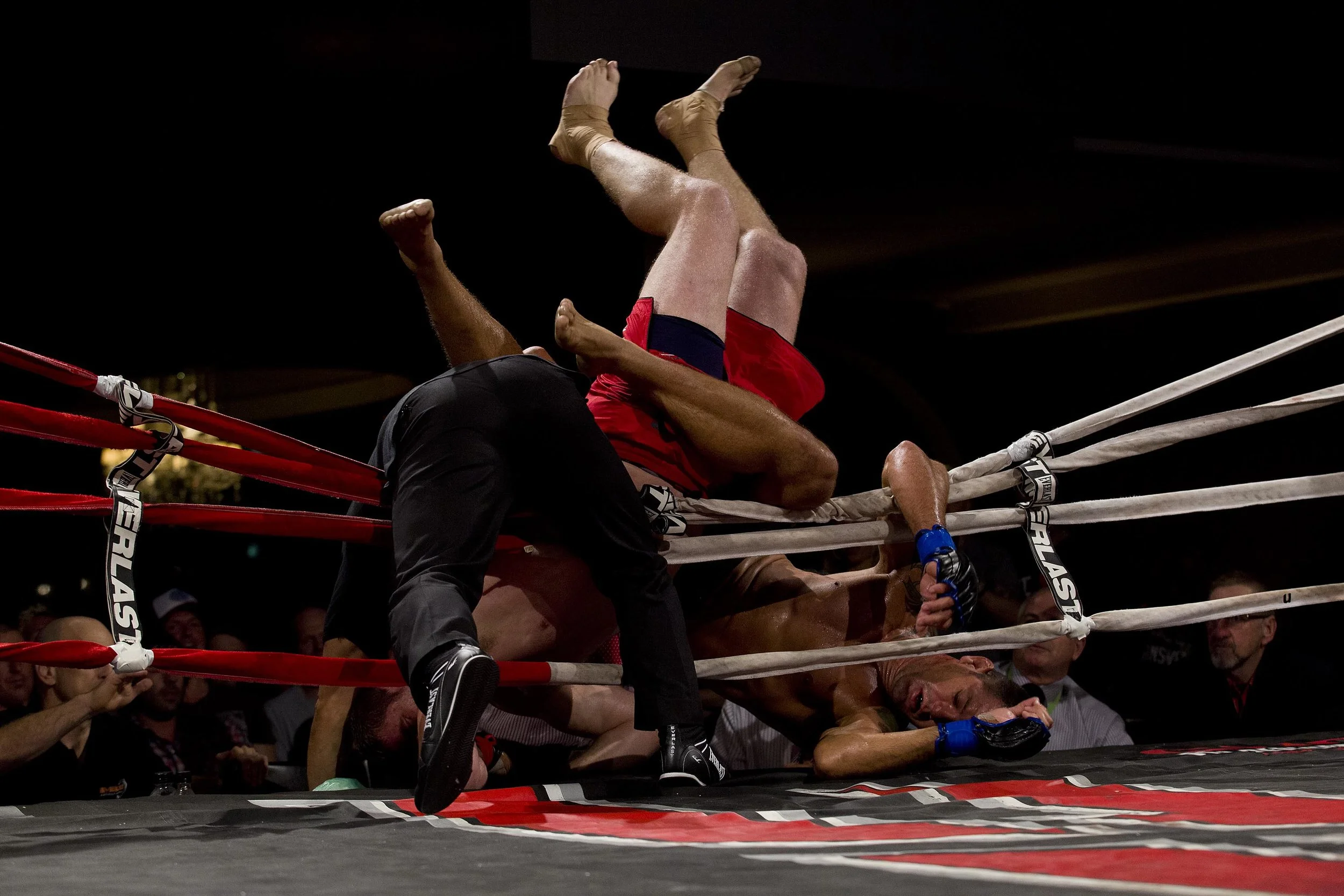  Fabio Galeb and Daniel Kelly wrestle over the ring and onto the judges table at the Australian Fighting Championship, Melbourne Pavilion, Victoria. 