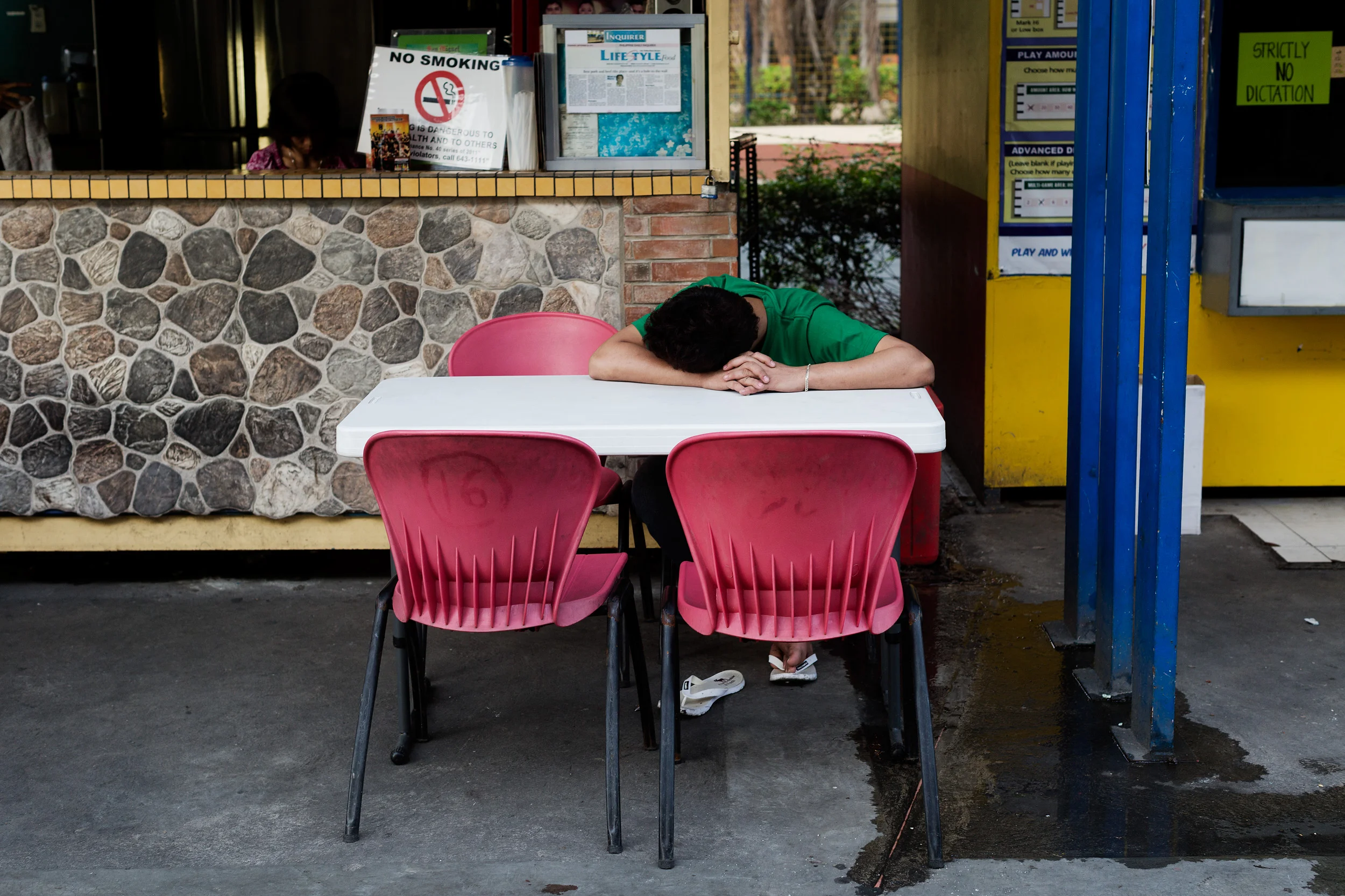  A man sleeps at a convenience stall early in the morning in Ortigas, a BPO and call centre hub in Manila, Philippines. Workers adjust their body clock to parallel that of the country they service. 