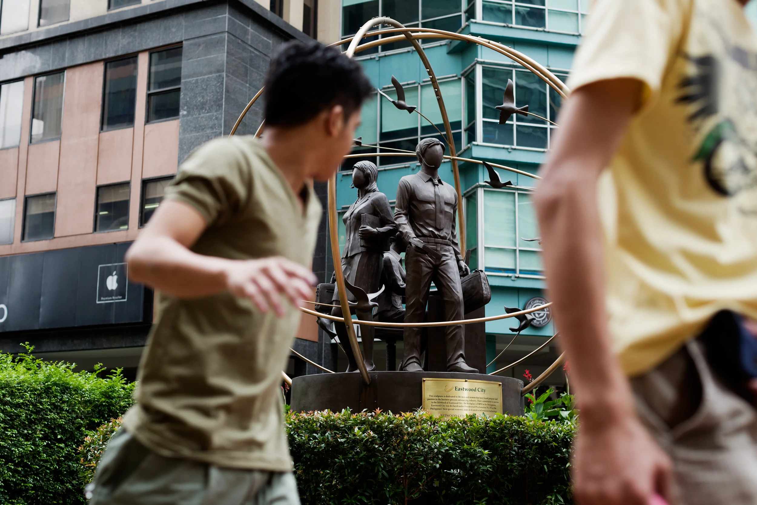  In Eastwood City, a BPO hub of in Manila, a monument stands paying homage to call centre workers of the Philippines. The statues wear bronze headsets and carry briefcases. The statues have no face. 