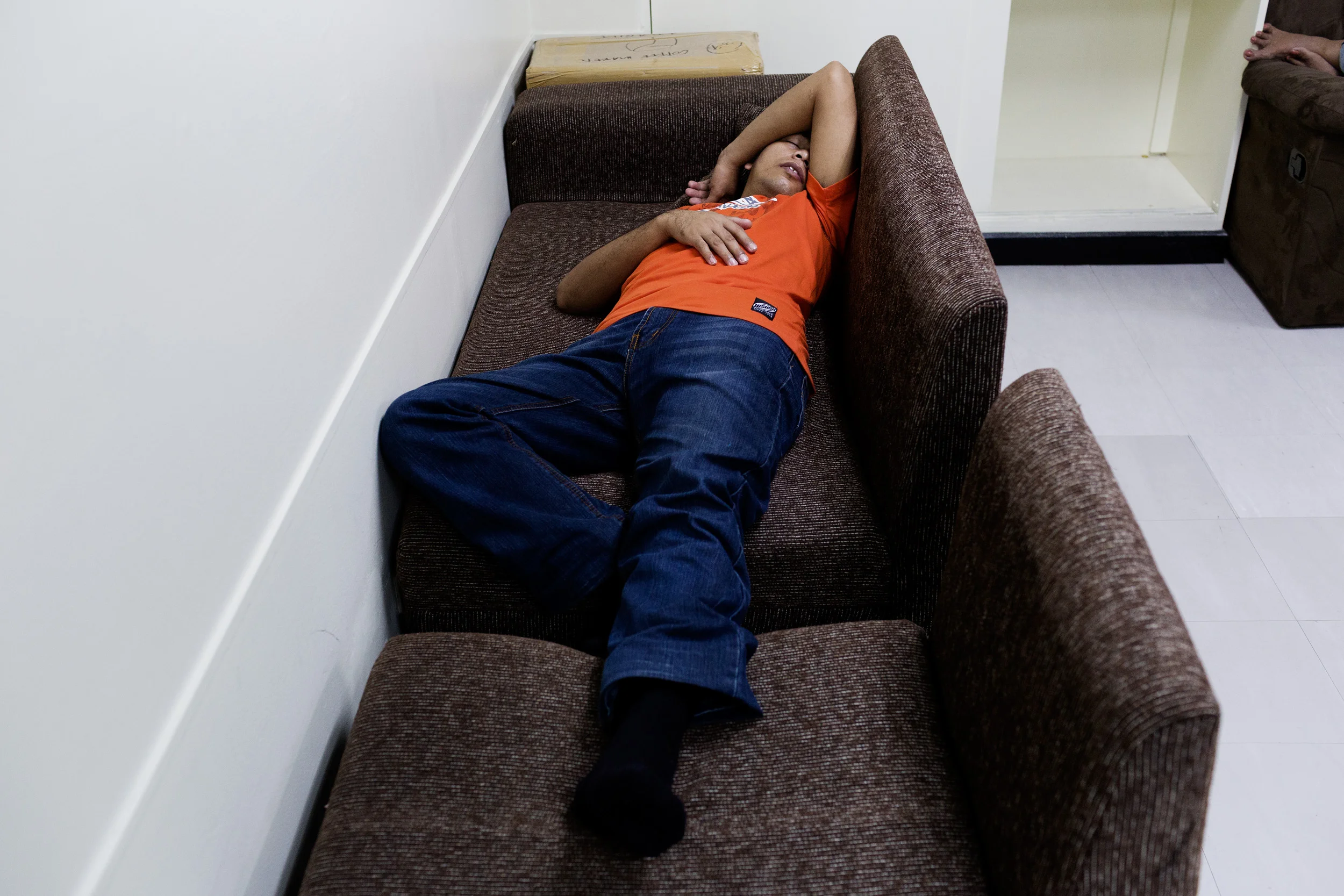  A call centre agent sleeps on his break from work at Pinoy Partners Outsourcing Center in Makati City, Philippines. Call centres have sleeping quarters that employees can utilise throughout their shift, and also during typhoons and natural disaster.