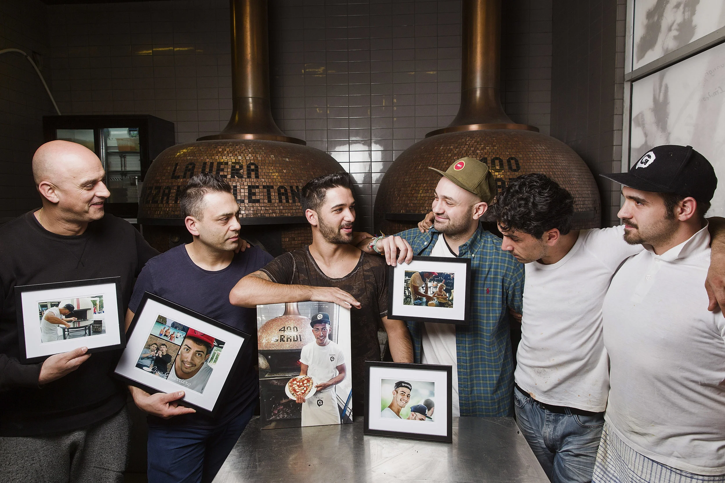  Kosta Kamboukos, Johnny Di Francesco, Luca Ruiu, Frank Scardamaglia, Fabio Parisi and Lorenzo Airaghi hold pictures of their friend and work colleague Gianluca Carlucci who worked at 400 Gradi as a chef, and was tragically killed in a motorcycle acc