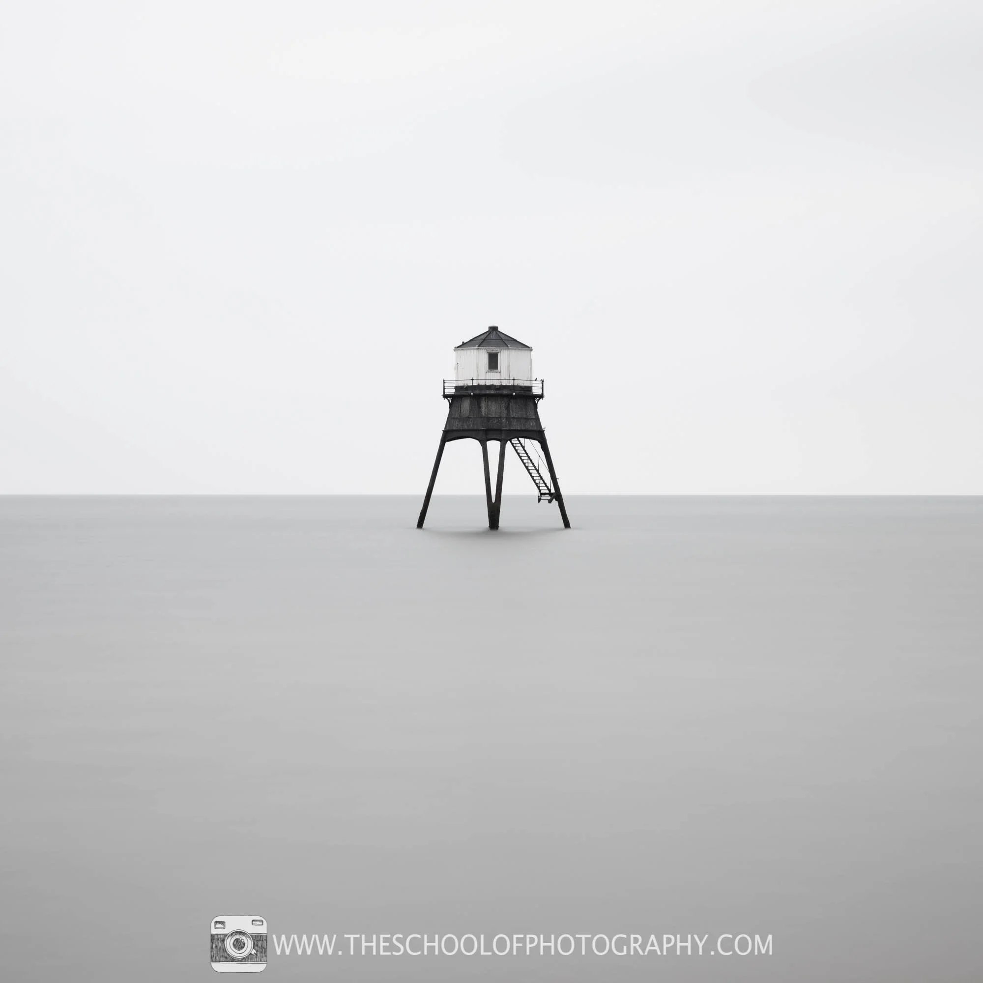 Black and white photo of a lighthouse out at sea
