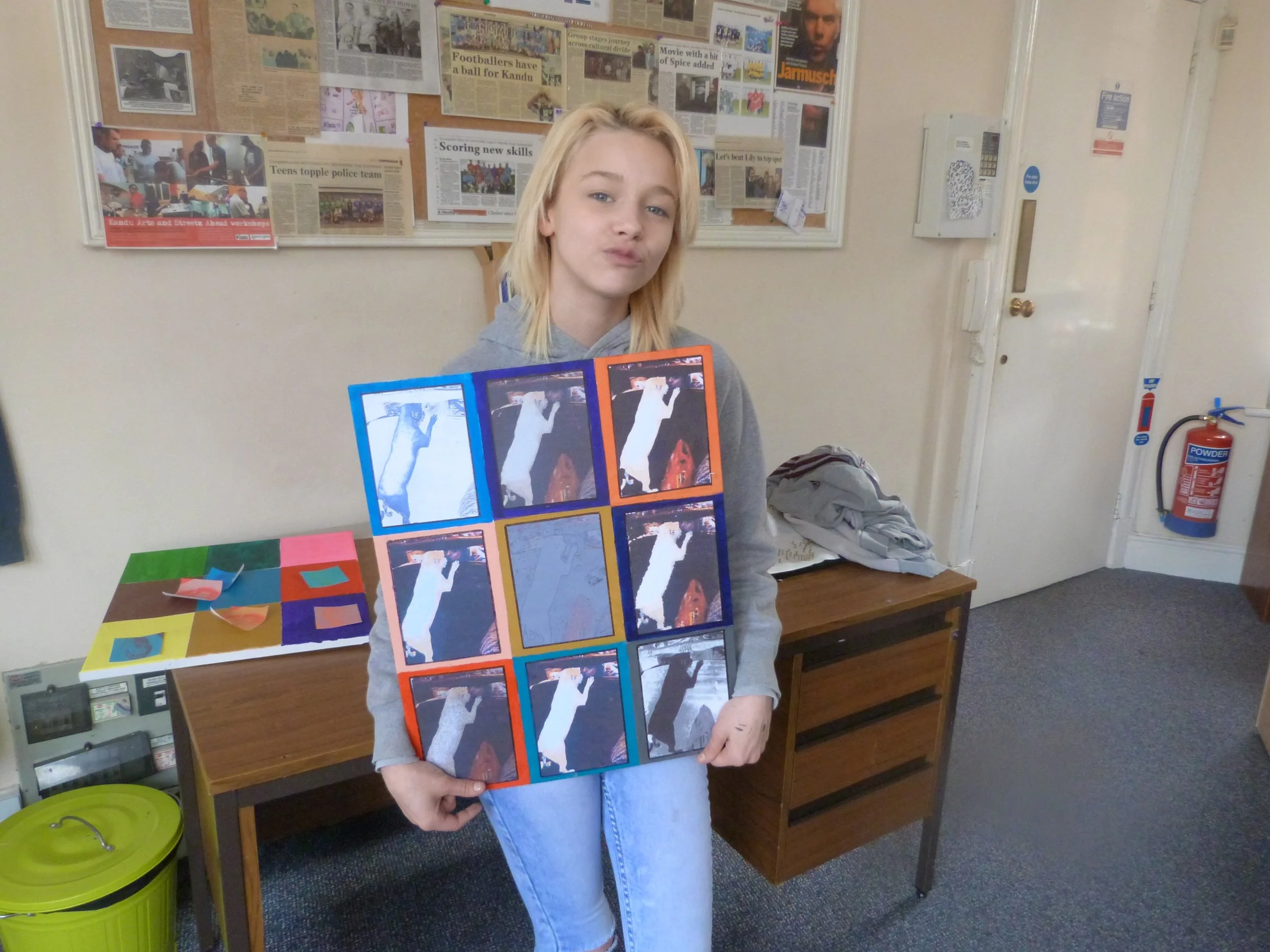 A young person proudly presenting their work