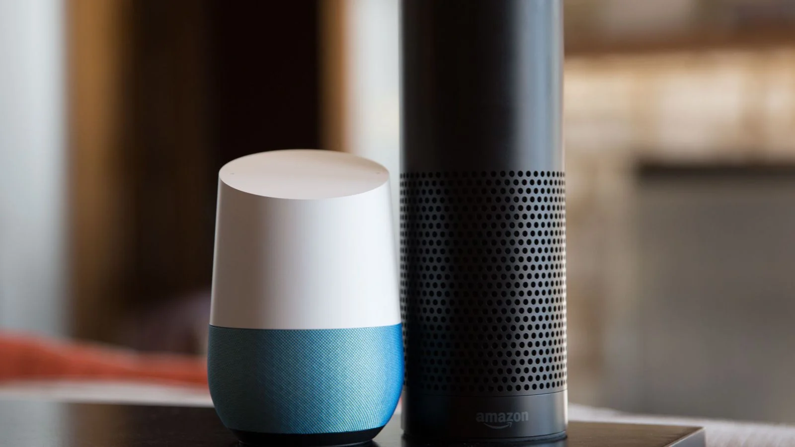 Google Home standing next to Amazon Echo