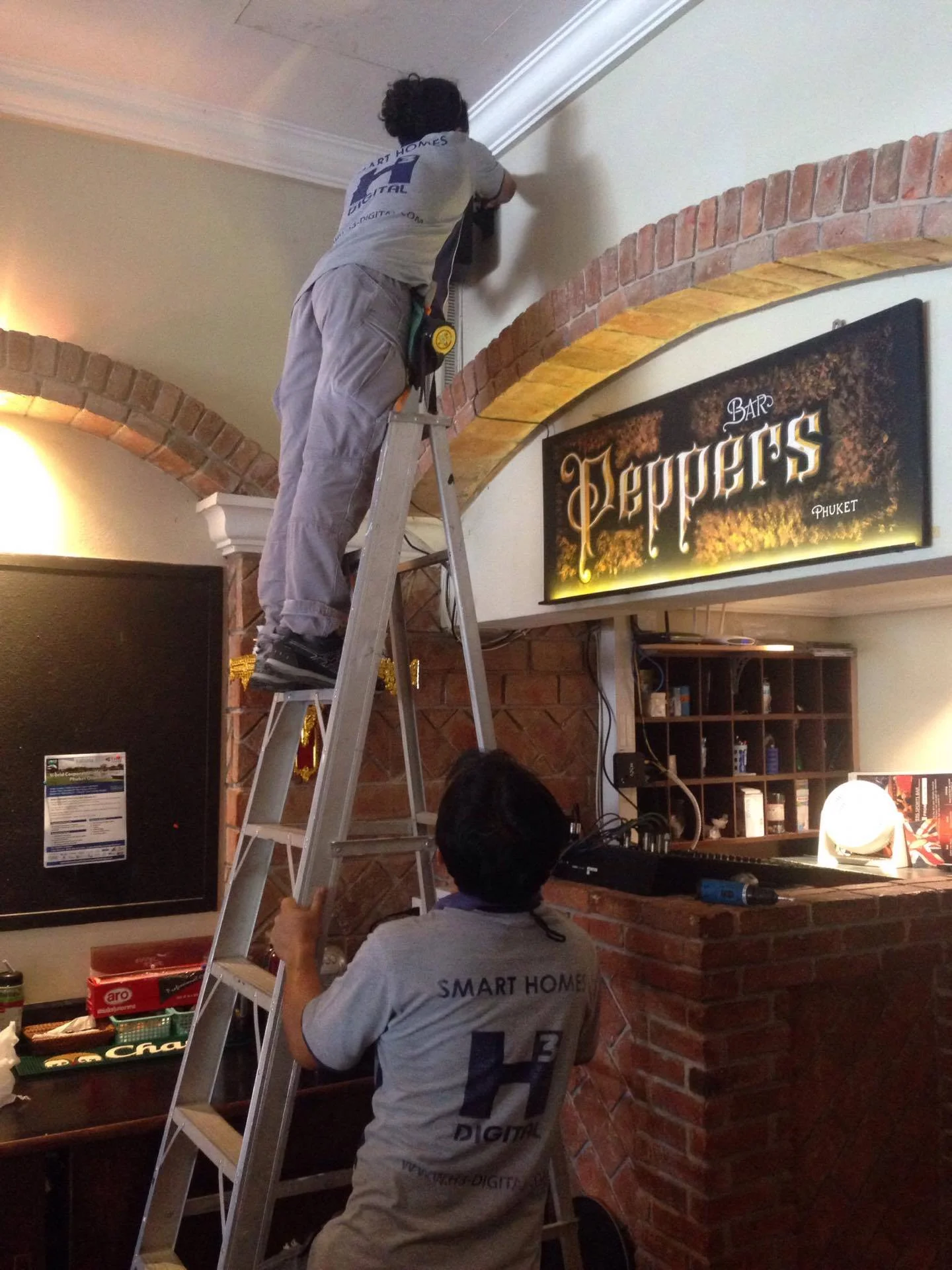 Installing the speakers above the mixing desk.