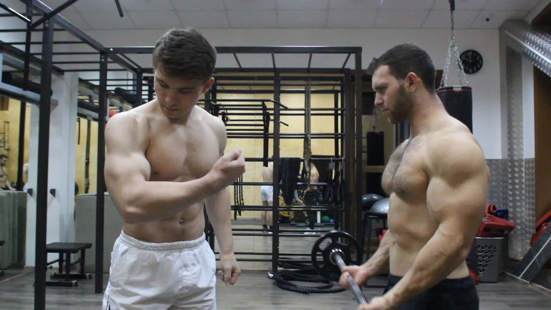 Two Musclest Brothers Flexing Together And Training In Gym