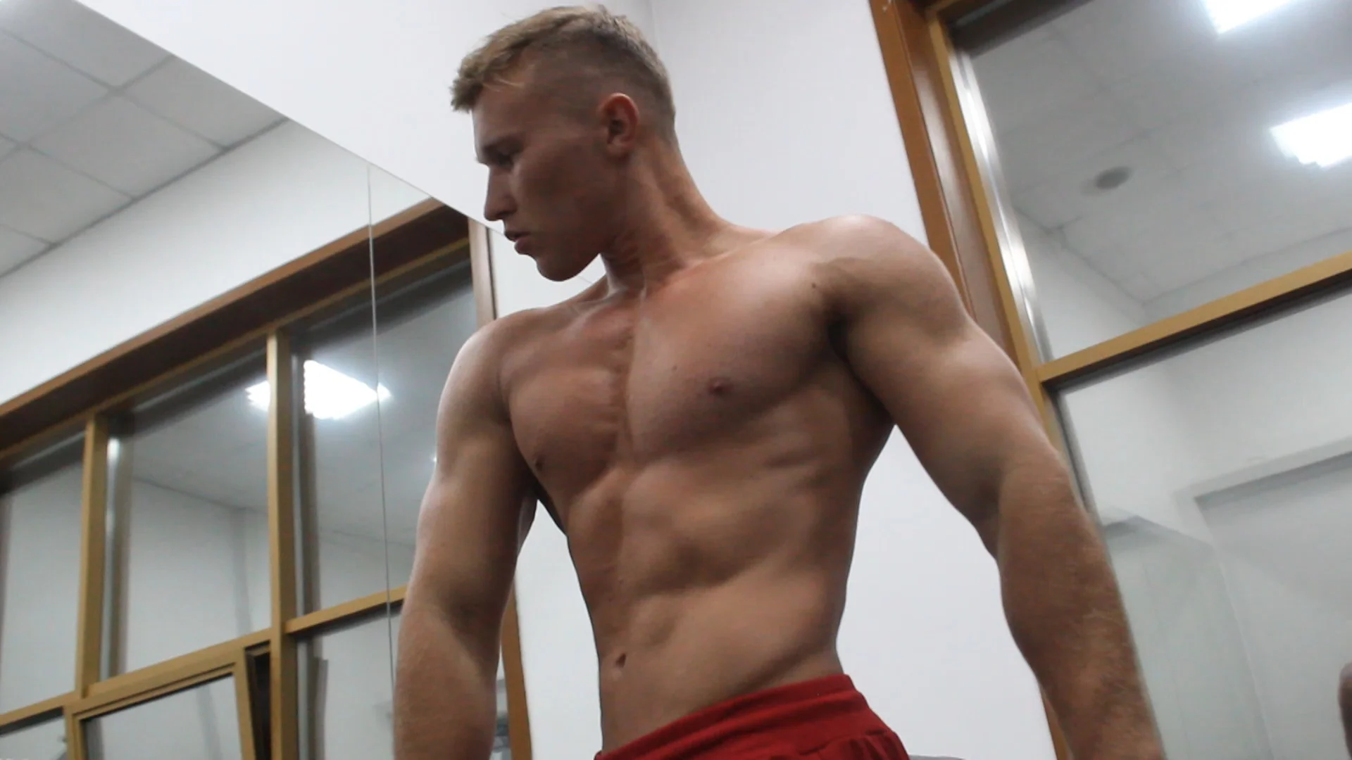 Two professional bodybuilders Sema and Sergey training hard and flexing together