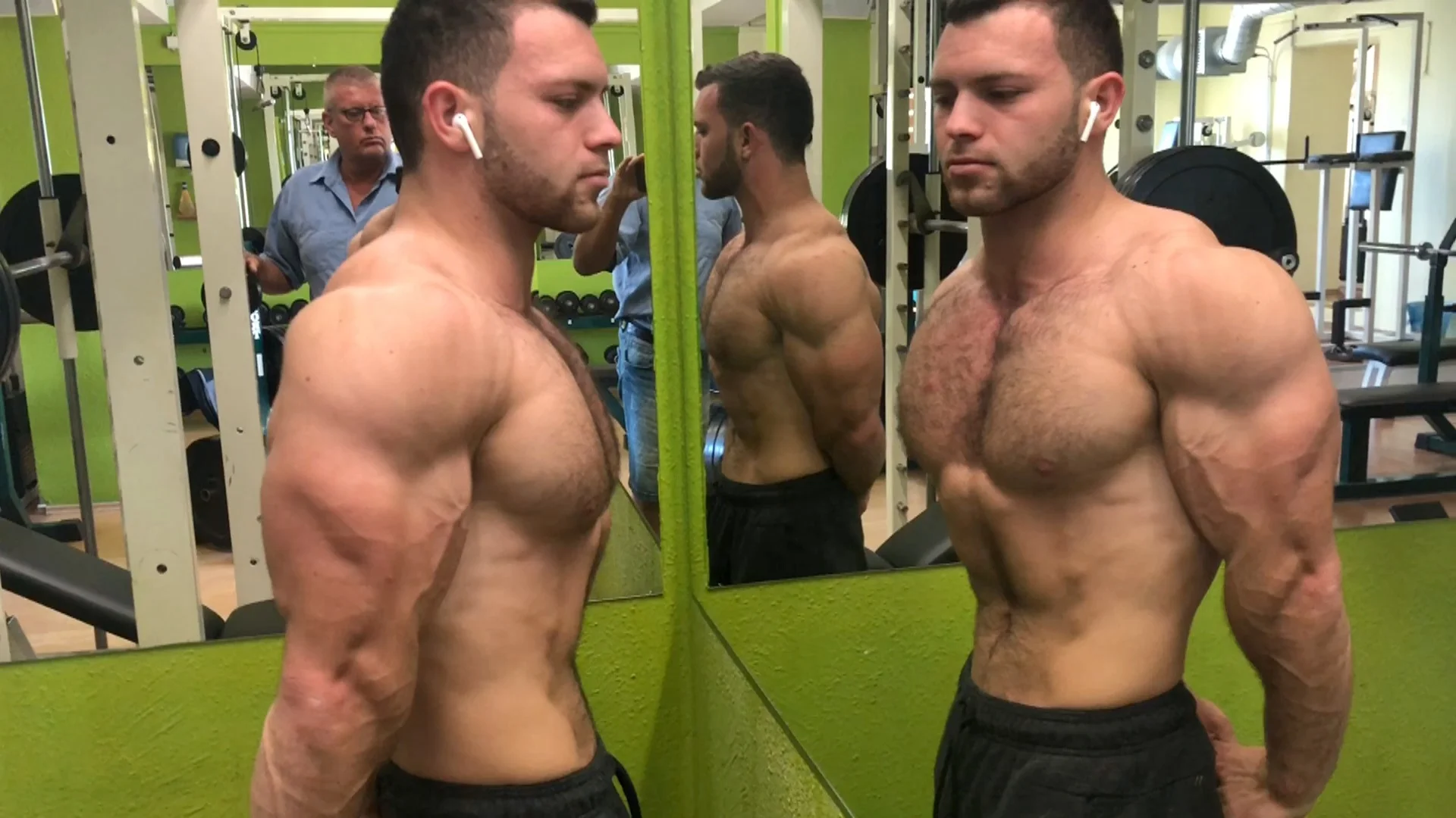 Sergey in gym with maximum pumped up steel muscles