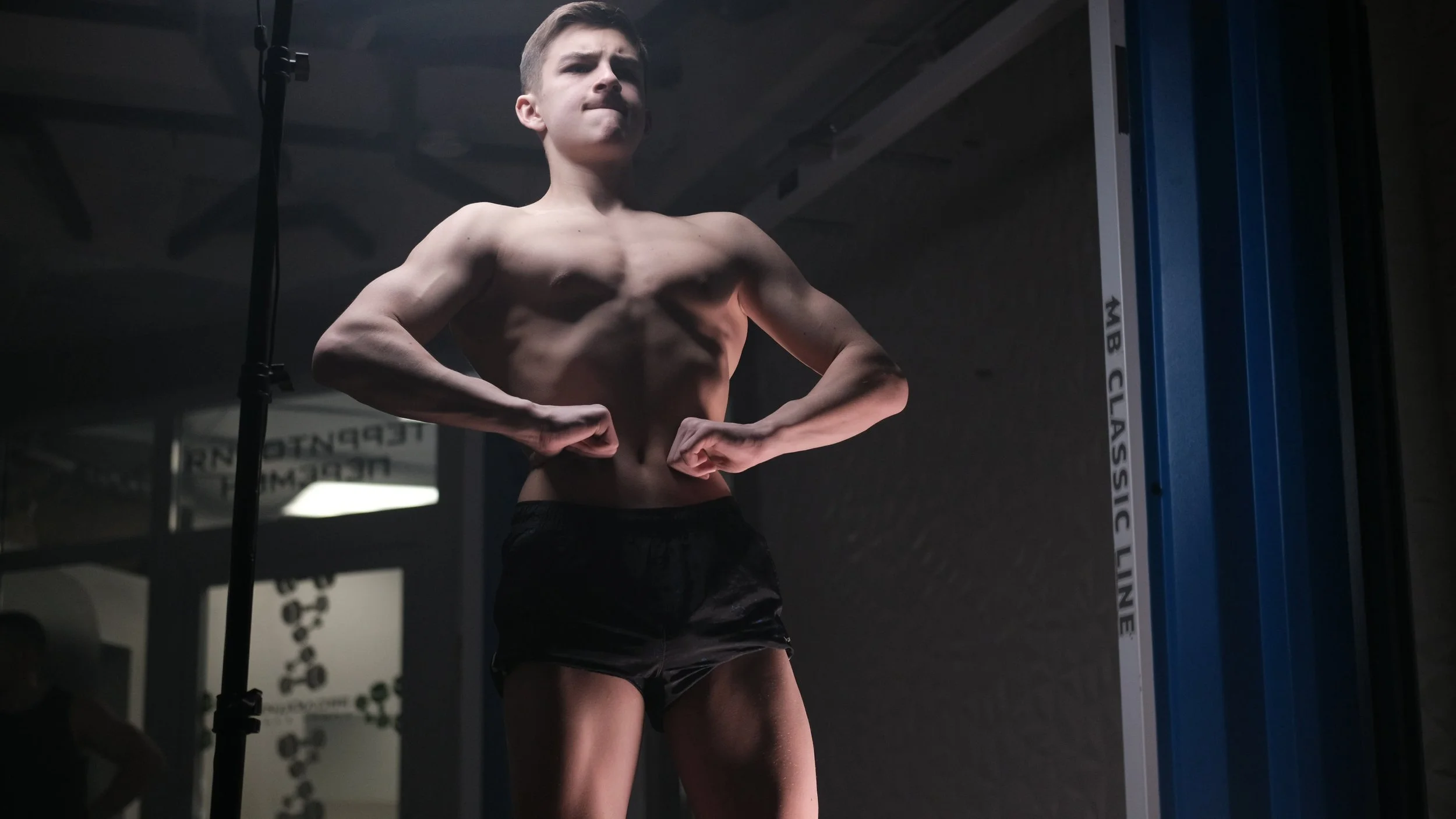 Strongest boy flexing with professional light