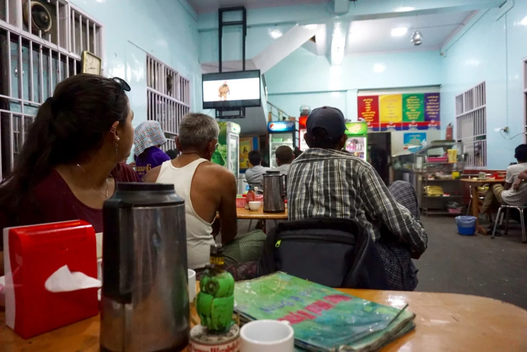 At night in Mandalay, everyone flocks to cafes playing action movies while sipping Burmese tea.