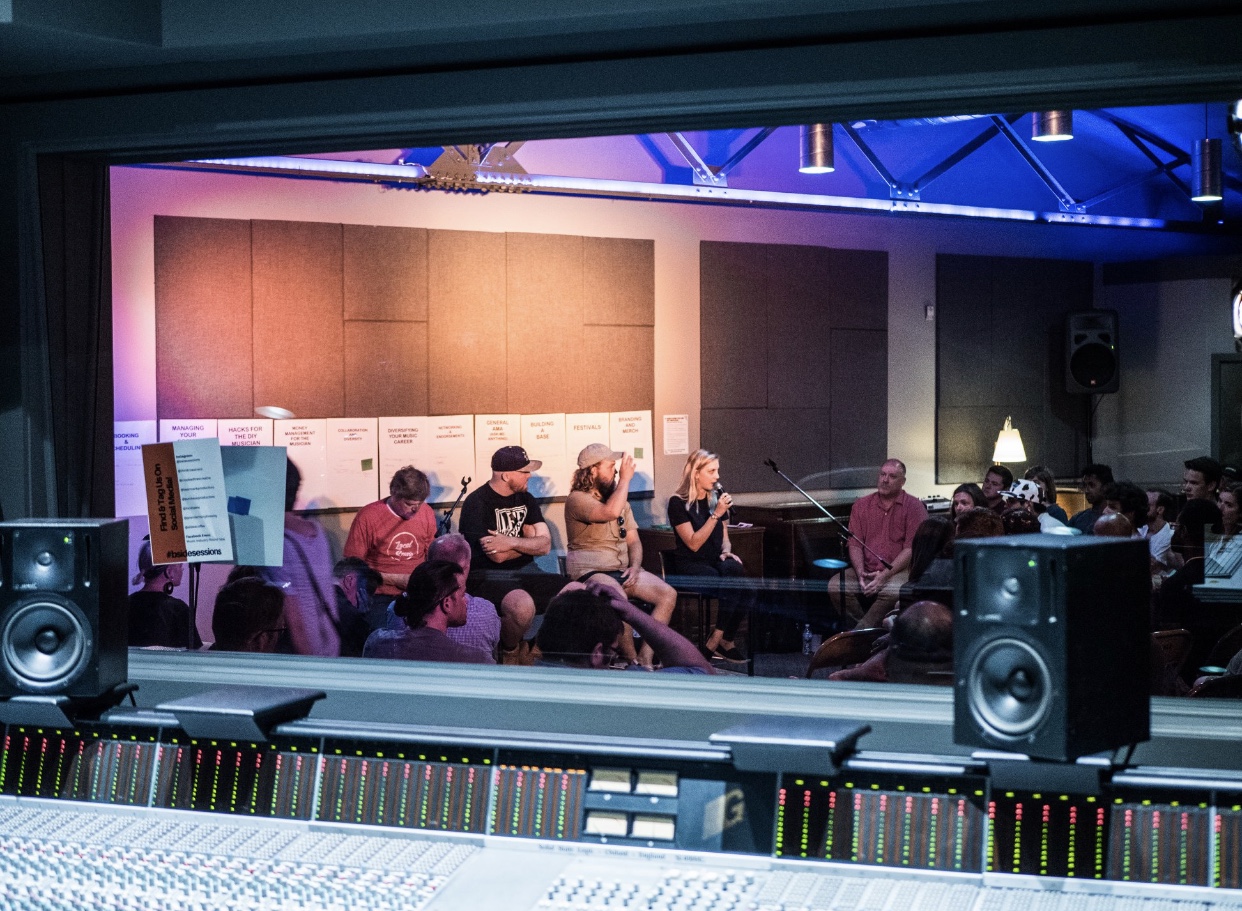 Photo Taken from inside of the studio A control room looking into live room A at the panel of speakers on Tuesday night’s event. Thank you to Mike Young for the photo.