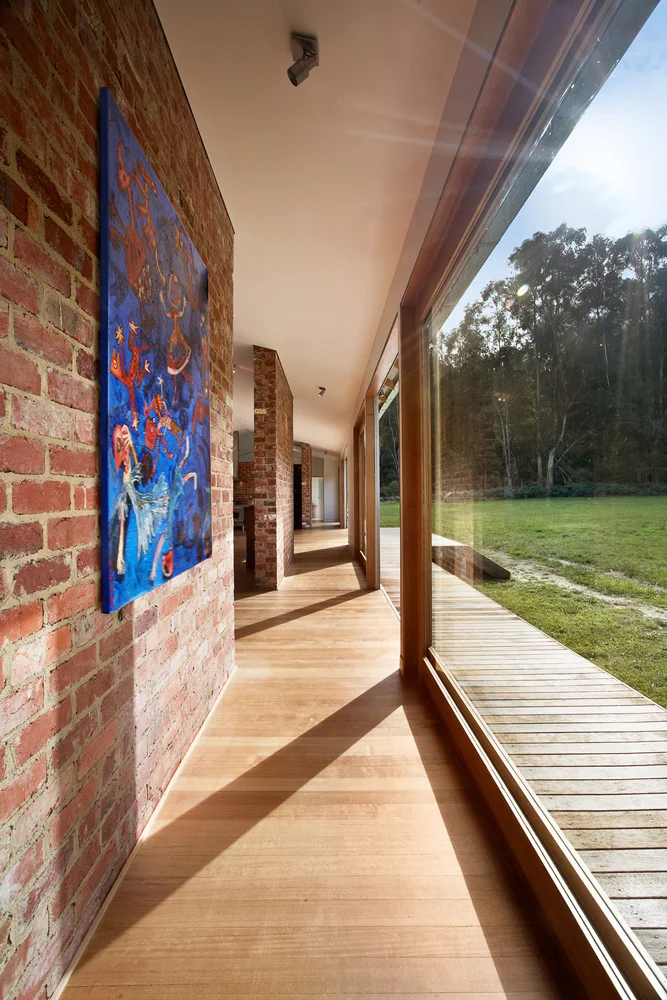 Reclaimed Brick Walls Hit with Natural Sunlight from Full Length Sliding Glass Doors