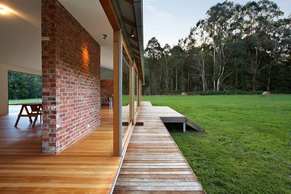 Recycled brick wall acting as a thermal heat bank wall for home