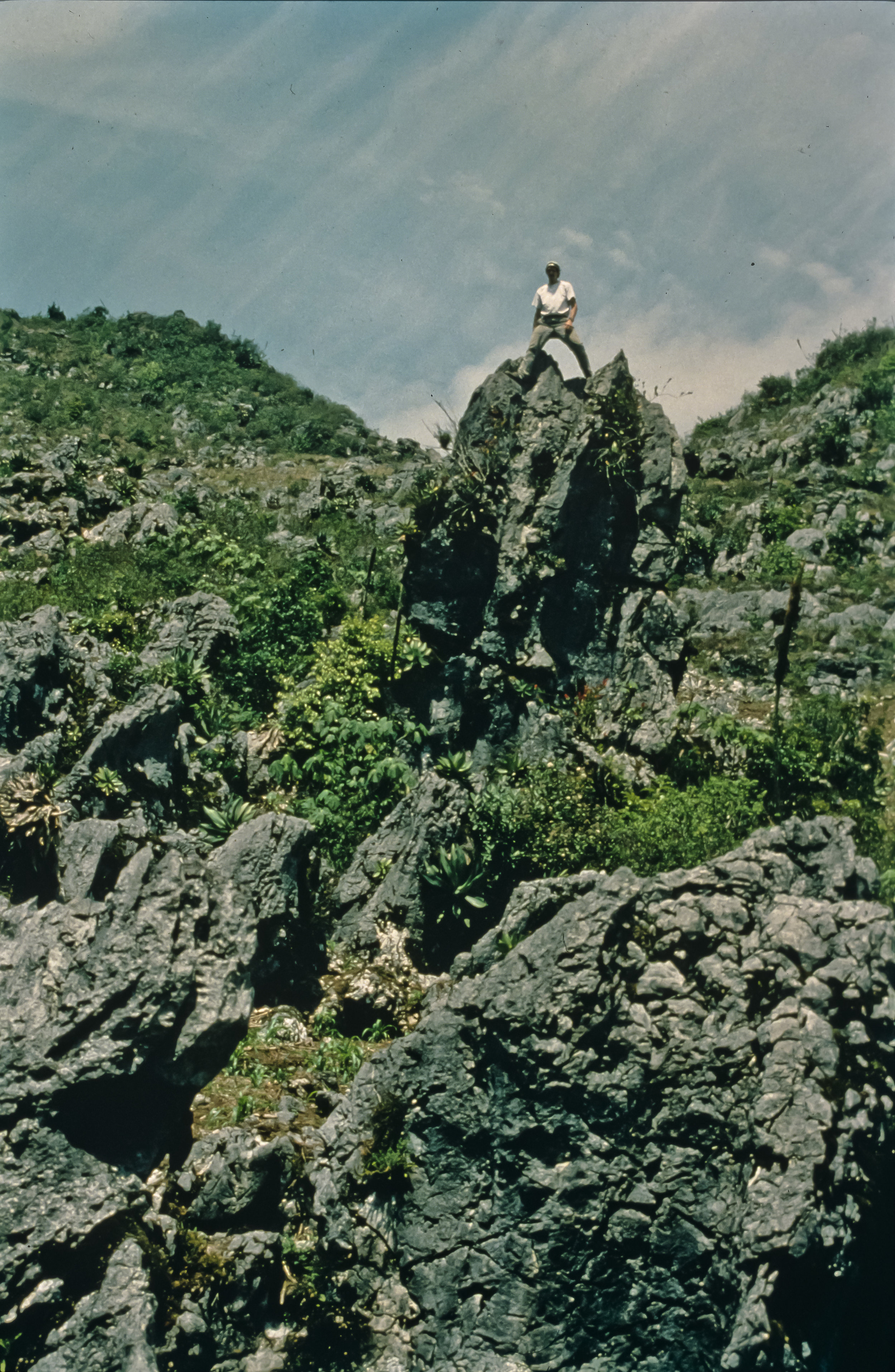  Bill Stone stands atop a spectacular karst pinnacle, one of many in the sinkholes between basecamp at the village of San Agustin Zaragoza and the southern rim of the Huautla Plateau. Photo by U. S. Deep Caving Team/Bill Stone. 