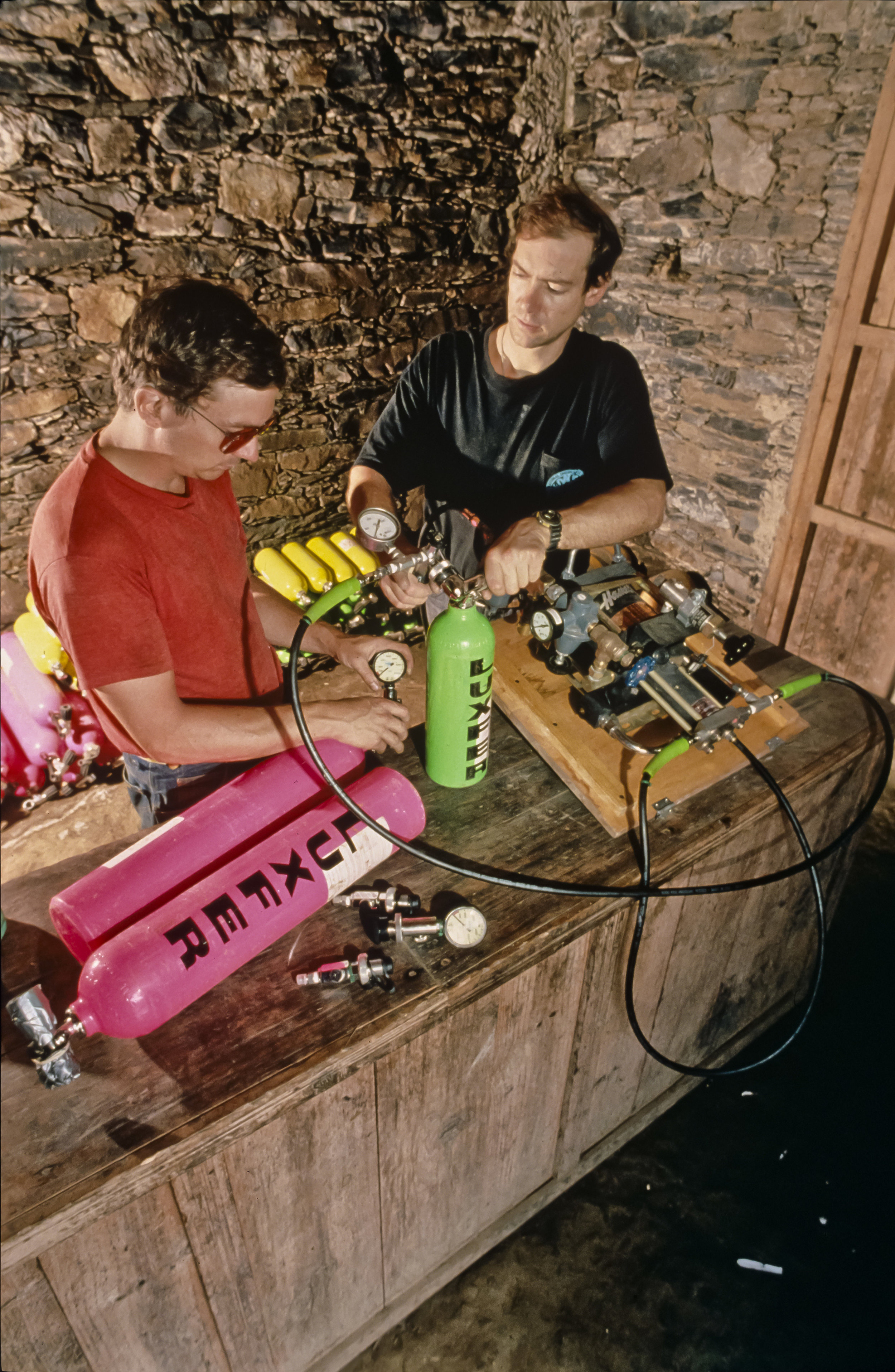  Jim Brown and Noel Sloan check out the gas recharging systems in the gear depot. Photo by U. S. Deep Caving Team/Bill Stone. 